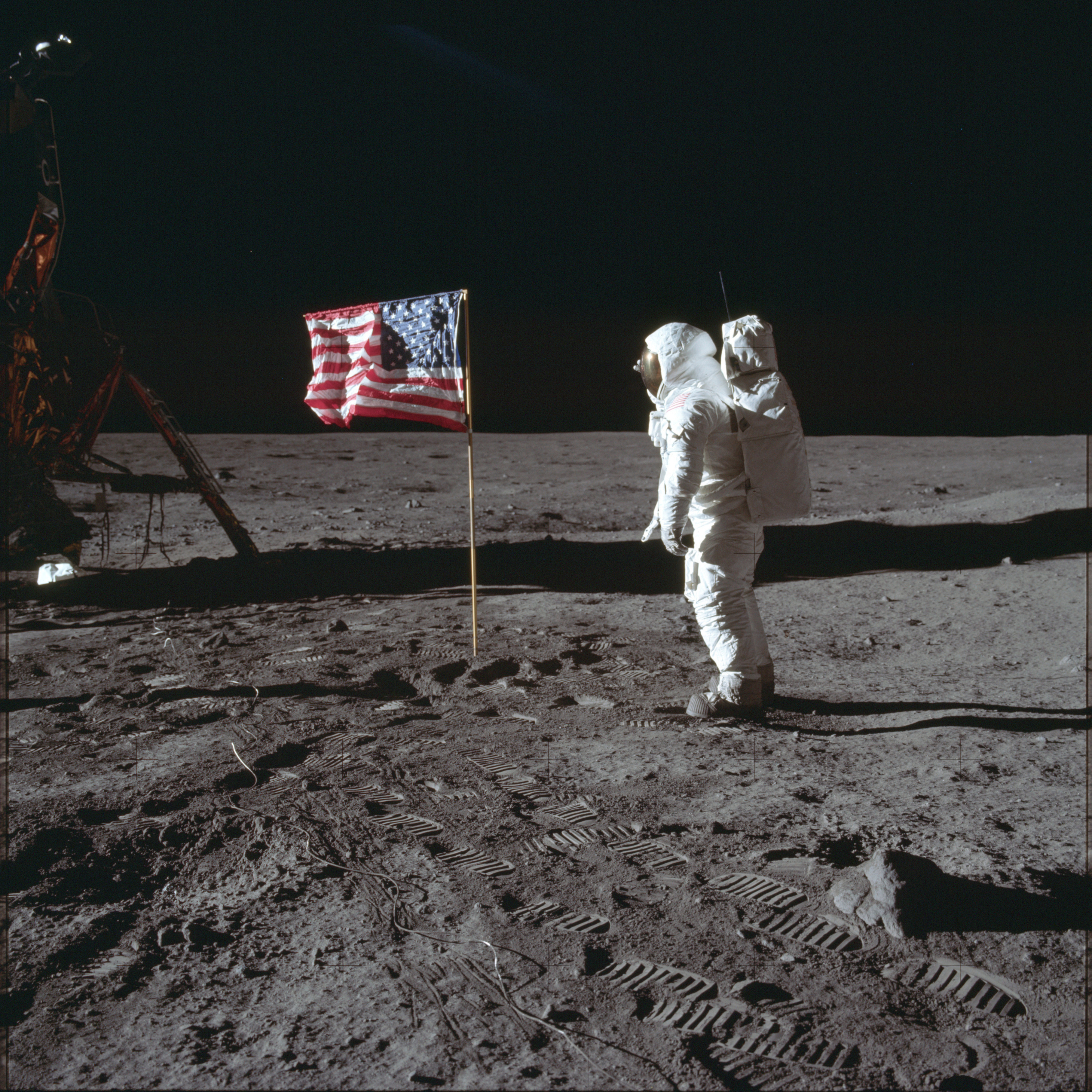 In this July 20, 1969, photo made available by NASA, astronaut Buzz Aldrin Jr. poses for a photograph beside the U.S. flag on the moon during the Apollo 11 mission. Aldrin's jacket worn on his historic first mission to the moon's surface in 1969 has been auctioned off to a bidder for nearly $2.8 million.