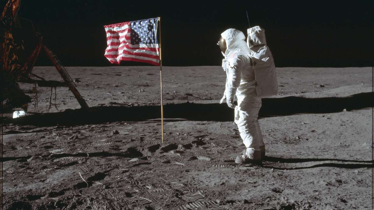 In this July 20, 1969, photo made available by NASA, astronaut Buzz Aldrin Jr. poses for a photograph beside the U.S. flag on the moon during the Apollo 11 mission. Aldrin's jacket worn on his historic first mission to the moon's surface in 1969 has been auctioned off to a bidder for nearly $2.8 million.