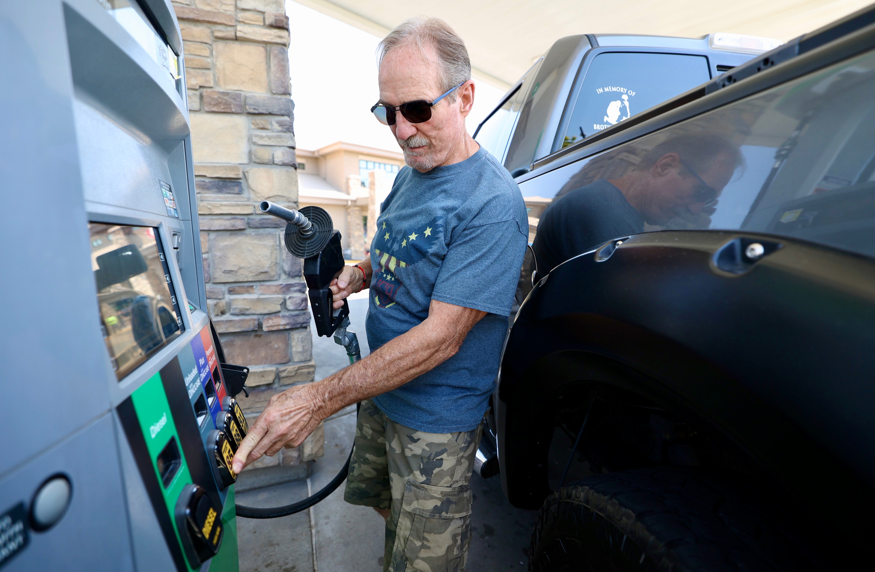 Drivers line up at All About Food & Fuel in Lehi including Max Smith for extra low-priced gas of $2.38 per gallon Tuesday morning.