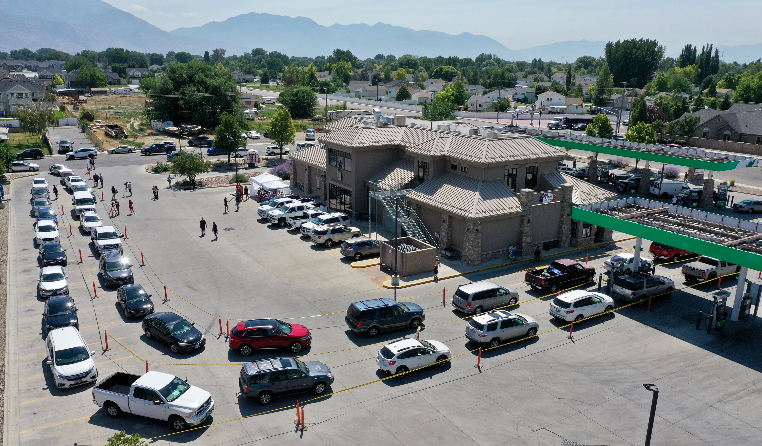 Drivers line up at All About Food & Fuel in Lehi for extra low-priced gas of  $2.38 per gallon Tuesday morning.