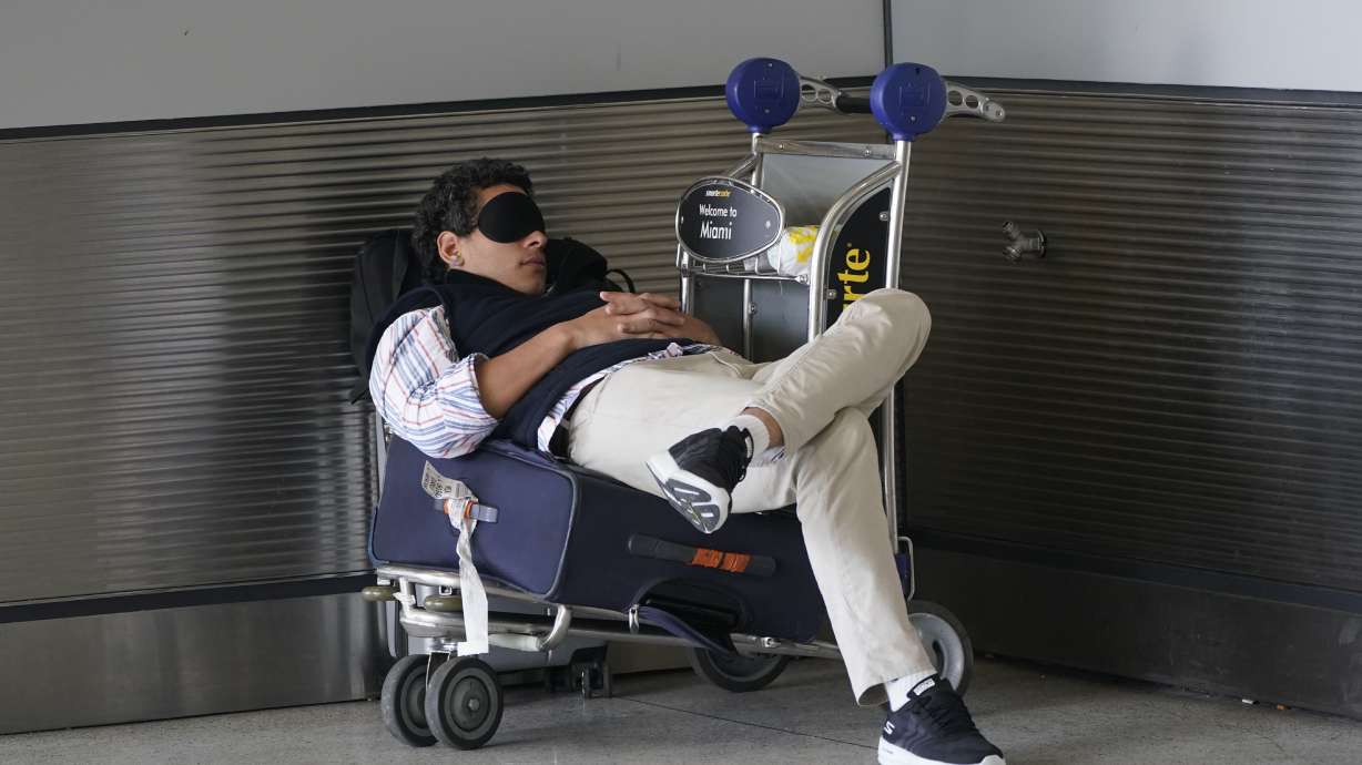 A traveler takes a nap as he waits for a ride outside Miami International Airport, July 1, in Miami. One study has linked frequent napping to high blood pressure and stroke.