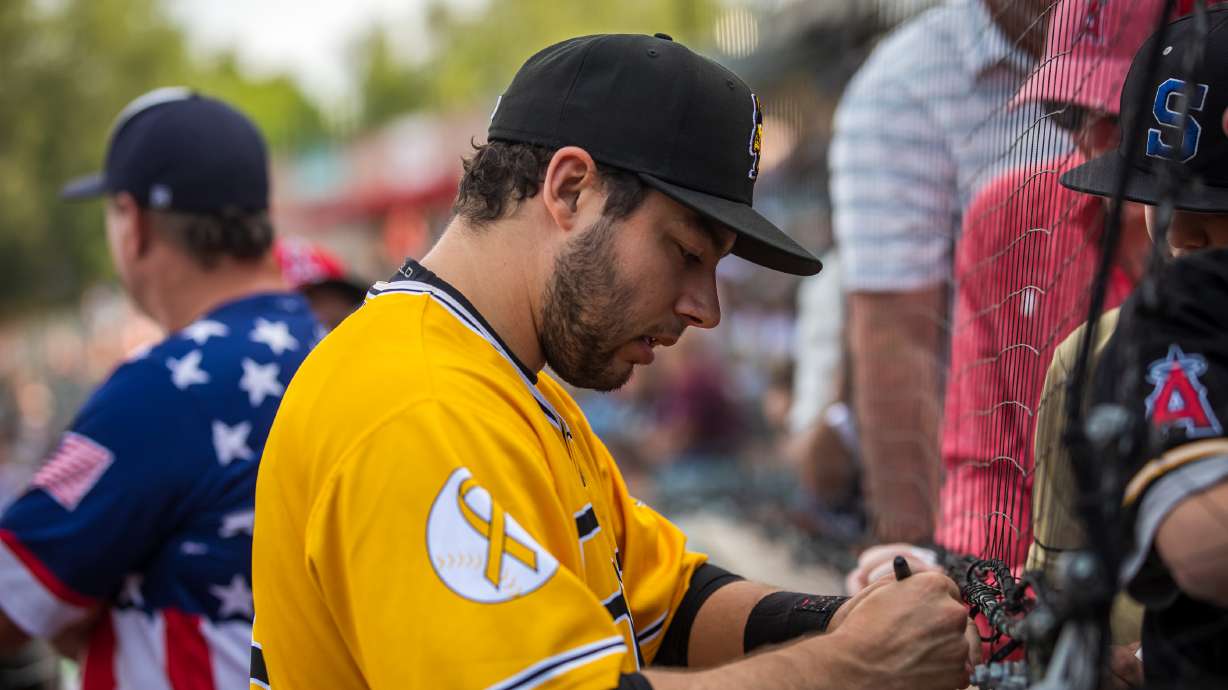 Salt Lake Bees infielder David Fletcher signs autographs for fans at Smith's Ballpark before a game Sunday night. Fletcher helped pull off a highlight reel play on Saturday.