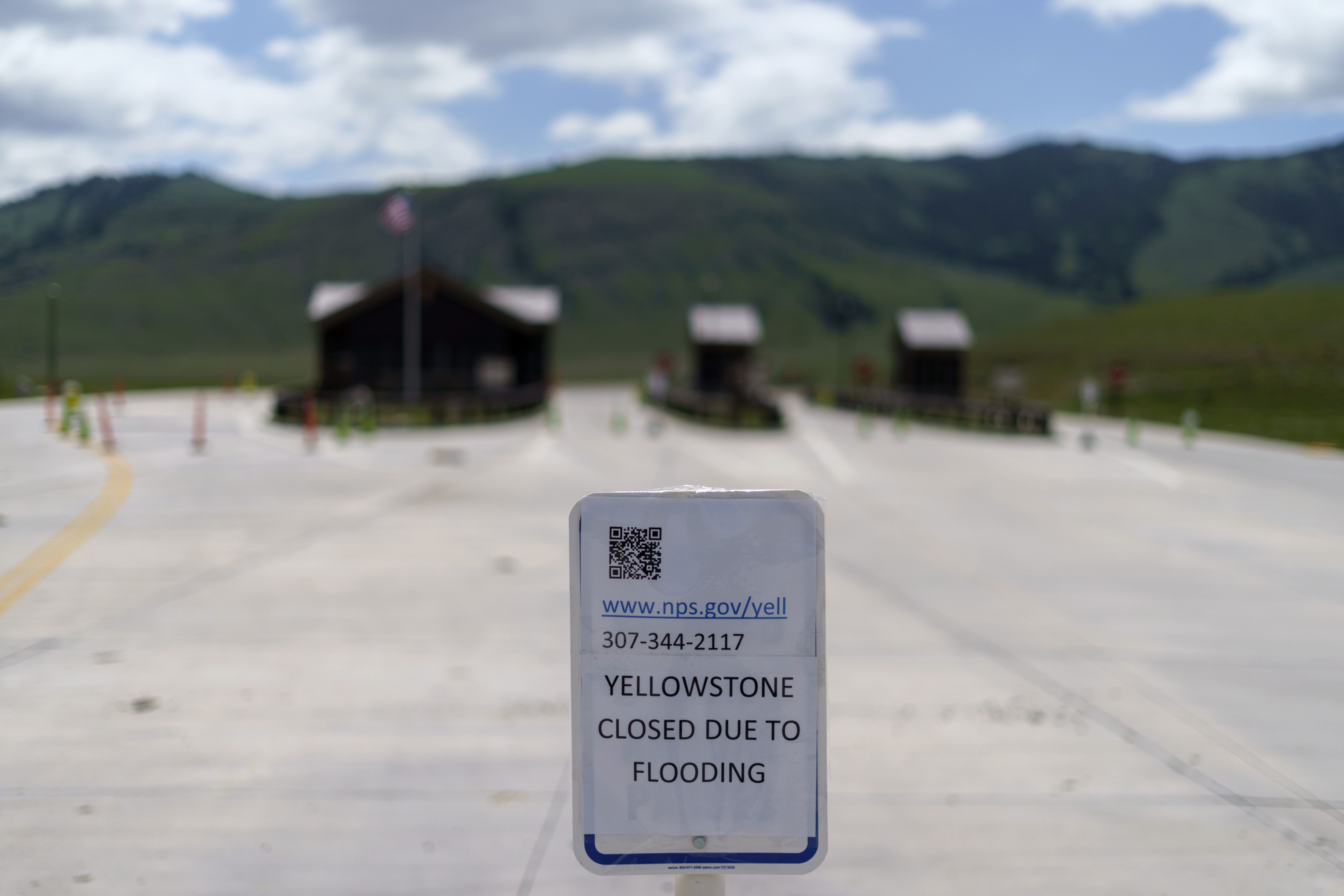 An entrance to Yellowstone National Park sits closed due to the historic floodwaters on June 15, in Gardiner, Mont. Visits to the park were down significantly in June and for the year.