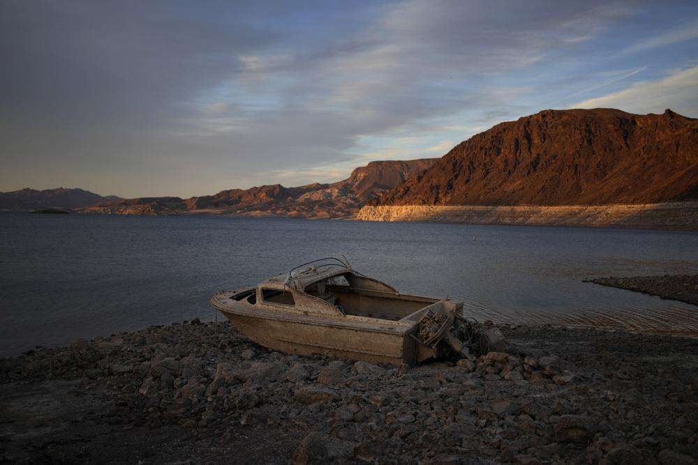 A formerly sunken boat sits high and dry along the shoreline of Lake Mead at the Lake Mead National Recreation Area, on May 10 near Boulder City, Nev. Wildfires, floods and soaring temperatures have made climate change real to many Americans.