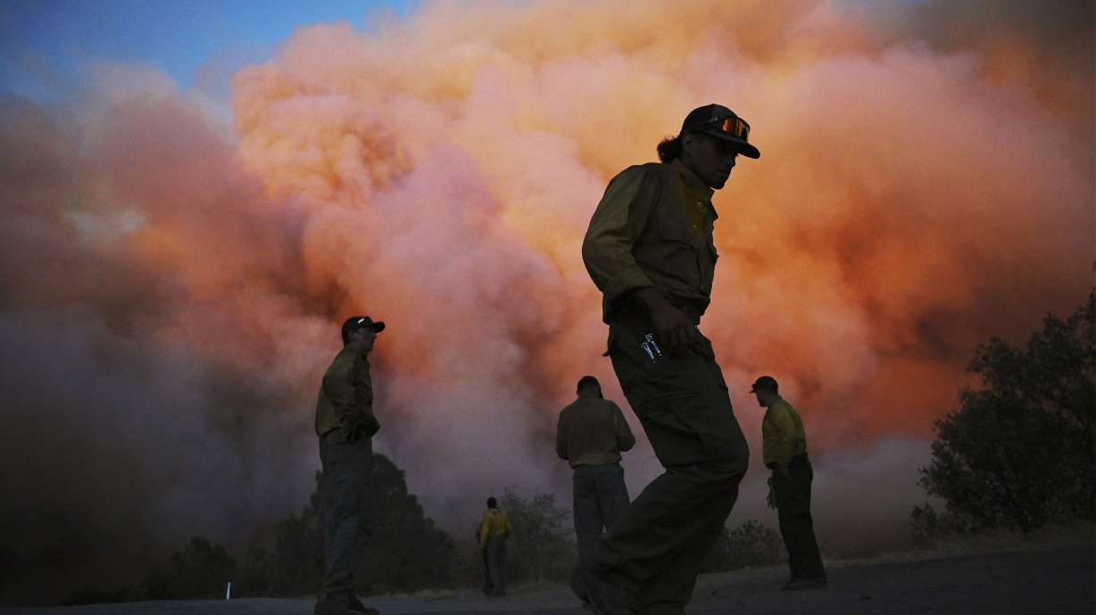 U.S. Forest firefighters watch a wildfire called the Oak Fire burn east of Midpines in Mariposa County, Calif., July 22. Despite much of the West seeing record rainfall in August, heightened wildfire conditions have returned to the region, coupled with abnormally high temperatures.