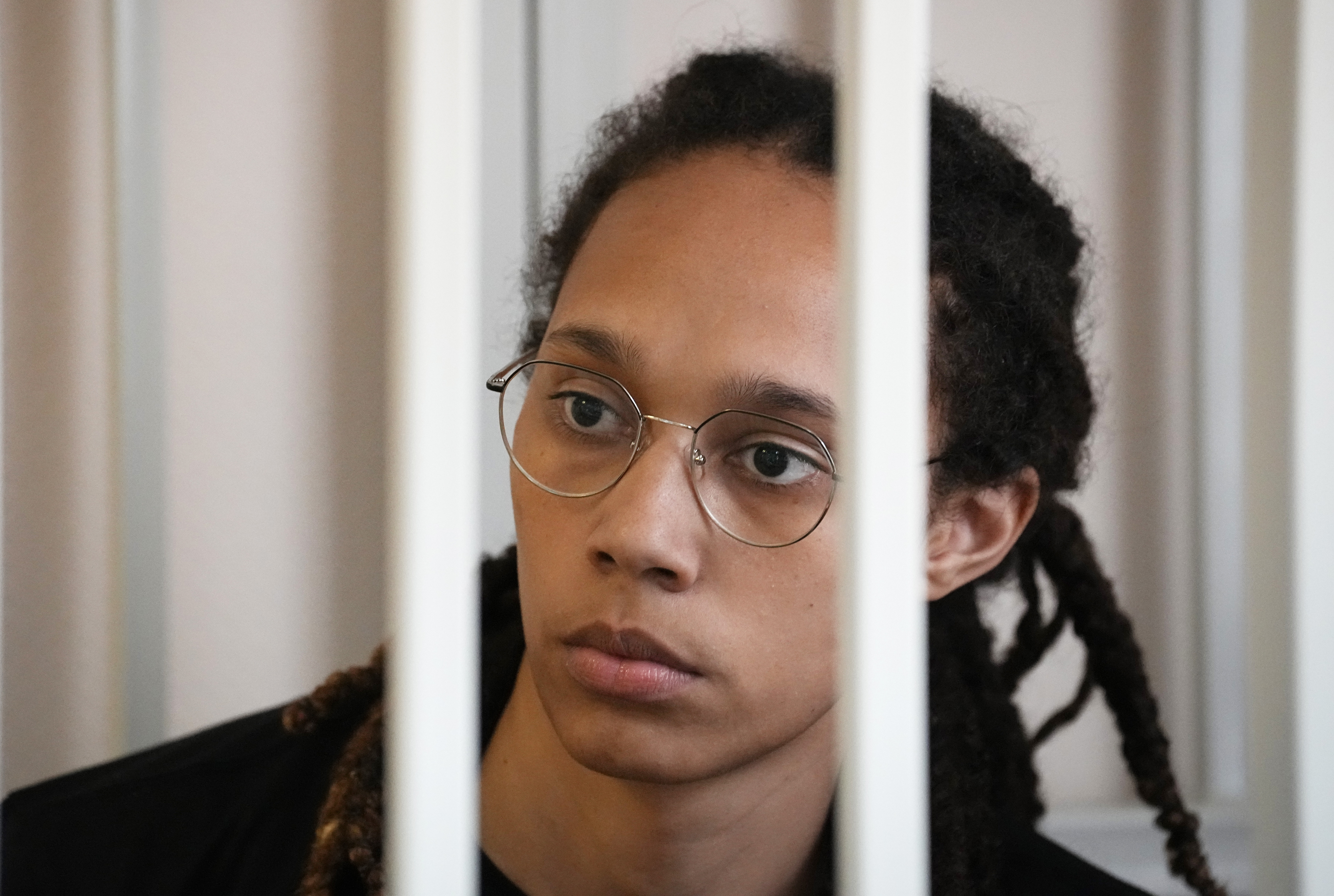 WNBA star and two-time Olympic gold medalist Brittney Griner sits in a cage at a court room prior to a hearing, in Khimki just outside Moscow, Russia, Wednesday, July 27, 2022. American basketball star Brittney Griner returned Wednesday to a Russian courtroom for her drawn-out trial on drug charges that could bring her 10 years in prison of convicted. 