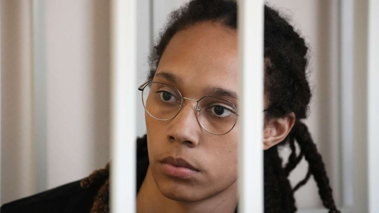 WNBA star and two-time Olympic gold medalist Brittney Griner sits in a cage at a court room prior to a hearing, in Khimki just outside Moscow, Russia, Wednesday, July 27, 2022. American basketball star Brittney Griner returned Wednesday to a Russian courtroom for her drawn-out trial on drug charges that could bring her 10 years in prison of convicted.