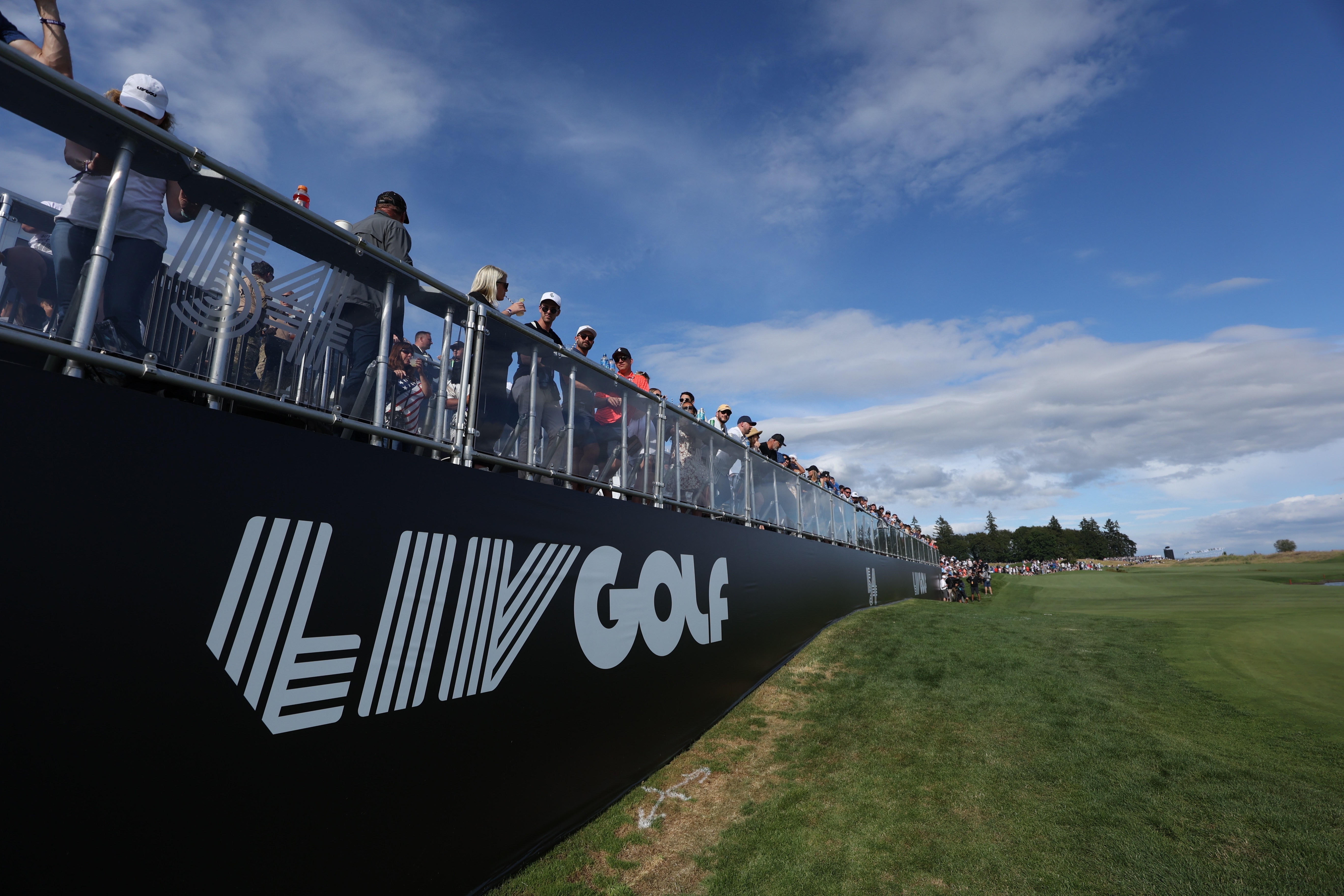 Fans await the final grouping at the 18th hole during the third round of the Portland Invitational LIV Golf tournament in North Plains, Ore., Saturday, July 2, 2022.