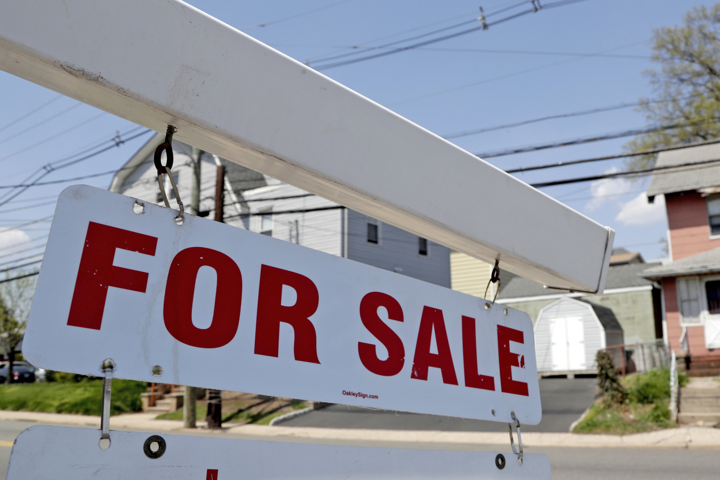 A "for sale" sign hangs from a post outside of a vacant business building in Belleville, N.J., May 3, 2018.  The Federal Reserve on Wednesday, raised its benchmark interest rate by a hefty three-quarters of a point for a second straight time in its most aggressive drive in three decades to tame high inflation.