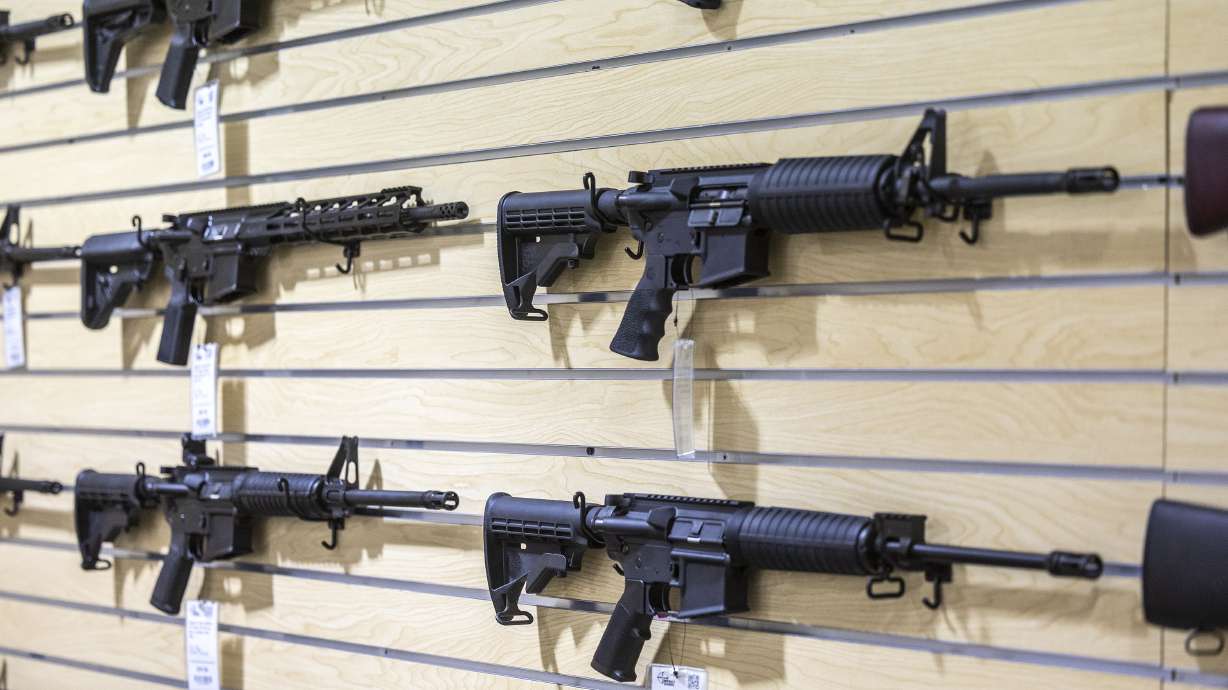 AR-15 rifles are displayed on a wall at Impact Guns in South Salt Lake on July 6. Sales of AR-15 style guns bring in big revenue for manufacturers, according to a report.