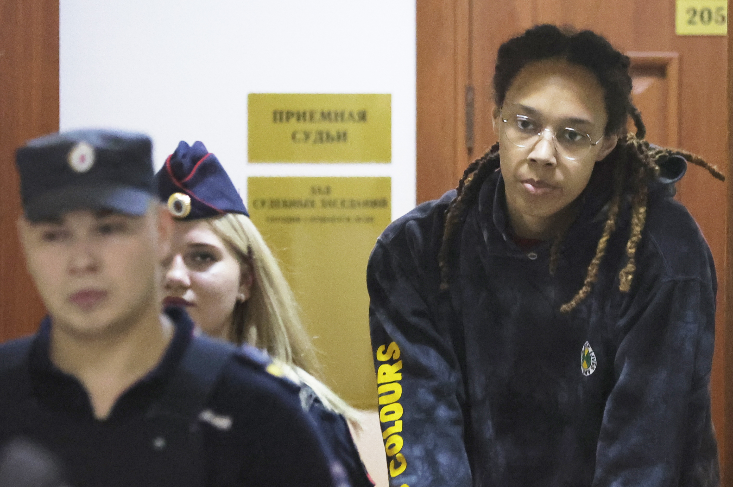 WNBA star and two-time Olympic gold medalist Brittney Griner is escorted to a courtroom for a hearing, in Khimki just outside Moscow, Russia, Monday, July 25, 2022. American basketball star Brittney Griner returns Tuesday to a Russian courtroom for her drawn-out trial on drug charges that could bring her 10 years in prison if convicted. 