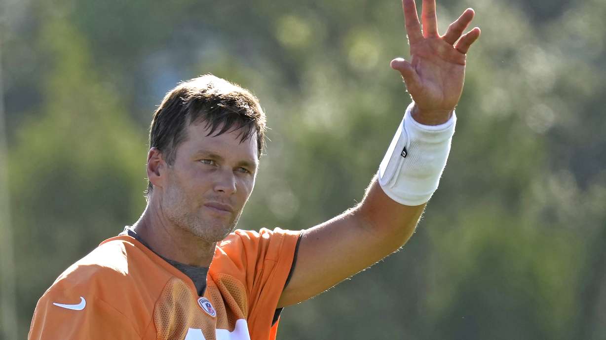 Tampa Bay Buccaneers quarterback Tom Brady waves to the fans during an NFL football training camp practice Wednesday, July 27, 2022, in Tampa, Fla.