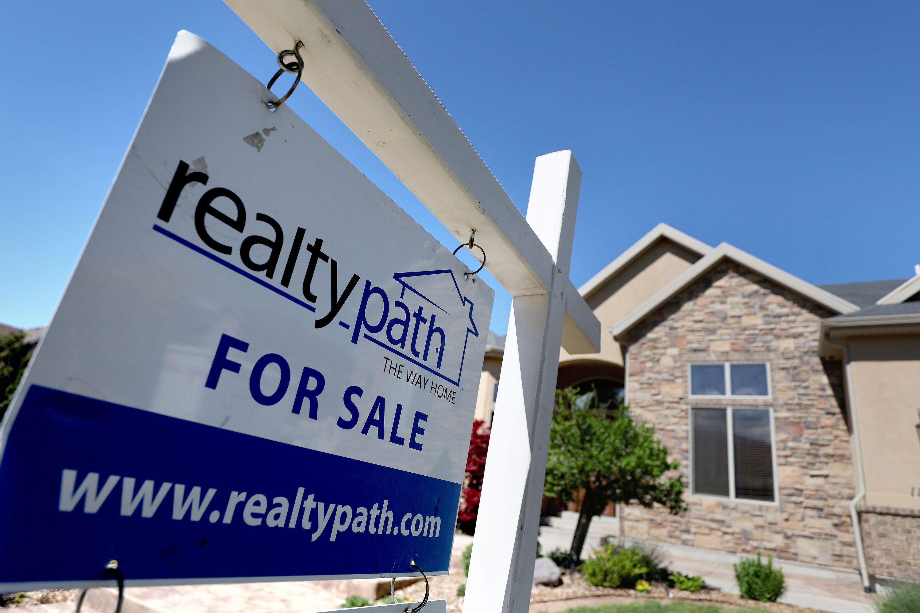 A “For Sale” sign is posted in the yard of a house in Sandy on May 31. What is the forecast for home prices in Utah? As the U.S. housing market hits a turning point, now cooling from red-hot to lukewarm, economists' predictions of what happens next are swirling. 