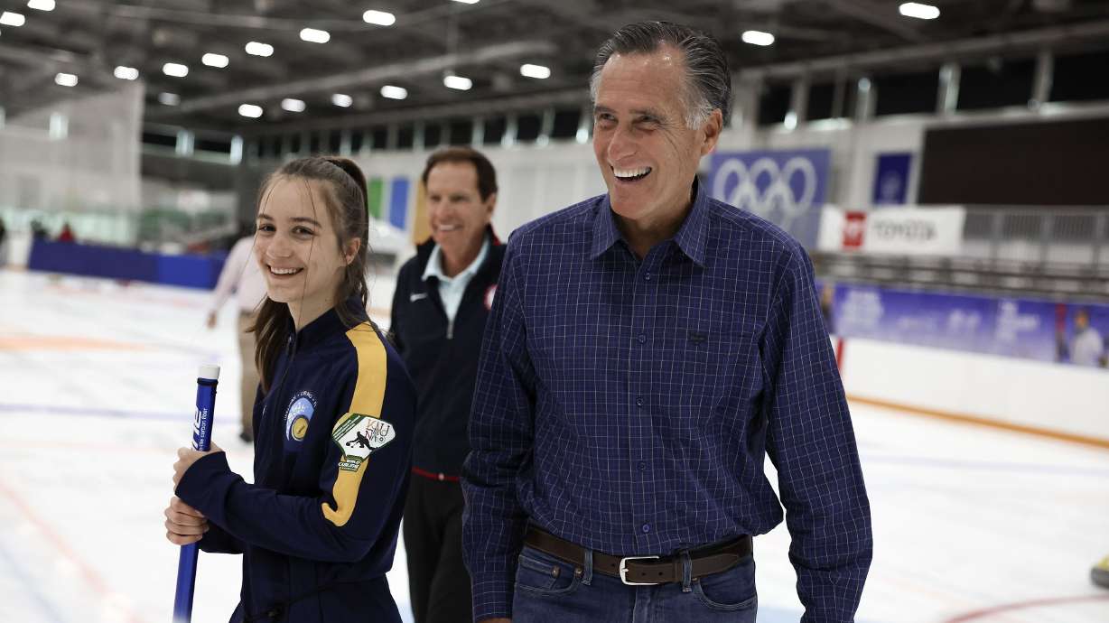 Sen. Mitt Romney, R-Utah, right, and Fraser Bullock, president and CEO of the Salt Lake City-Utah Committee for the Games, center, speak with Ukrainian Olympians at the Utah Olympic Oval in Kearns on May 27. Half of Utahns like the job Sen. Mitt Romney is doing in Washington, but the first-term Republican continues to find more favor with Democrats than he does within his own party in the Beehive State.