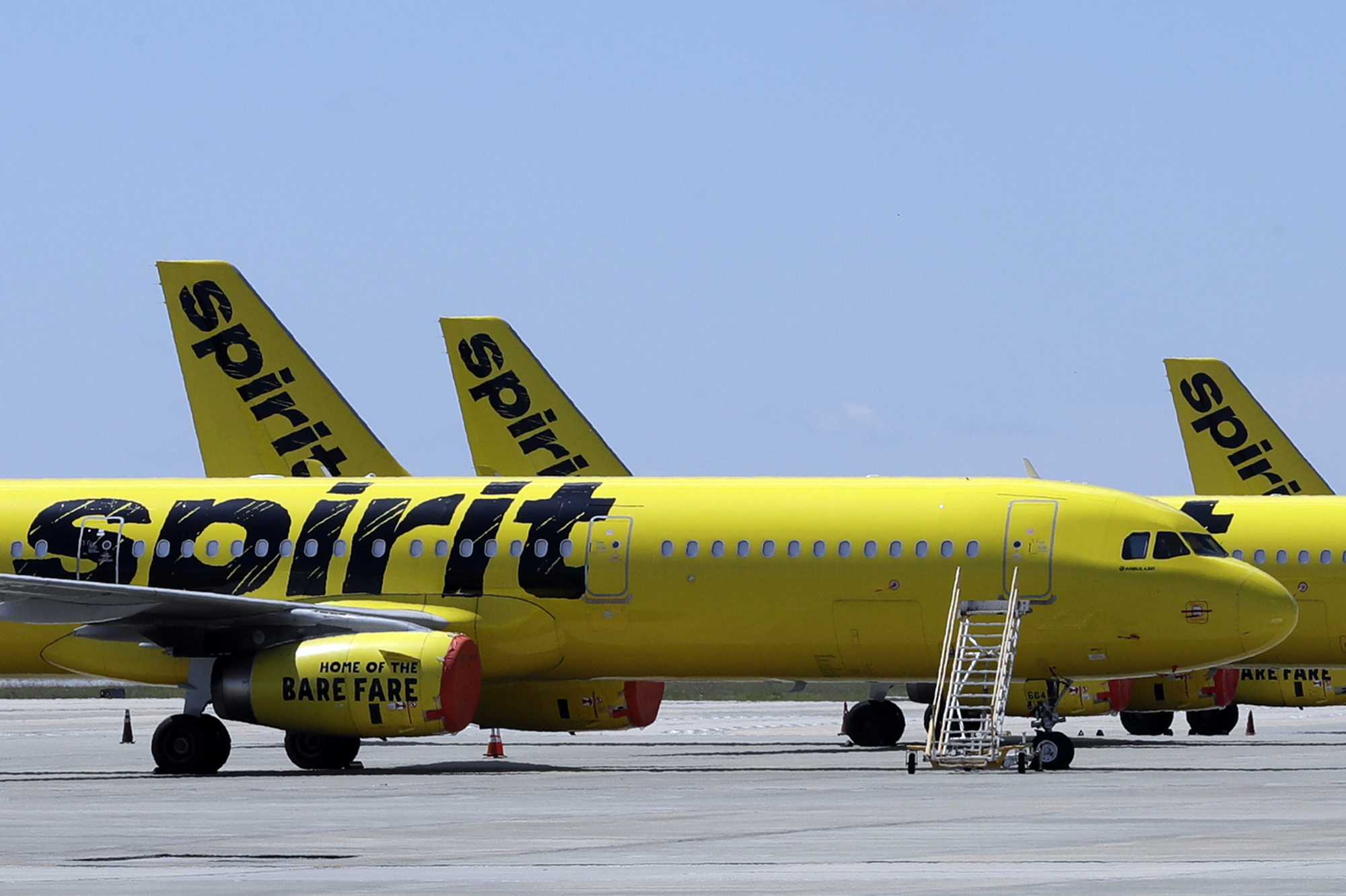 A line of Spirit Airlines jets sit on the tarmac at Orlando International Airport on May 20, 2020, in Orlando, Fla. JetBlue has agreed to buy Spirit Airlines in a $3.8 billion deal, according to a Thursday announcement.