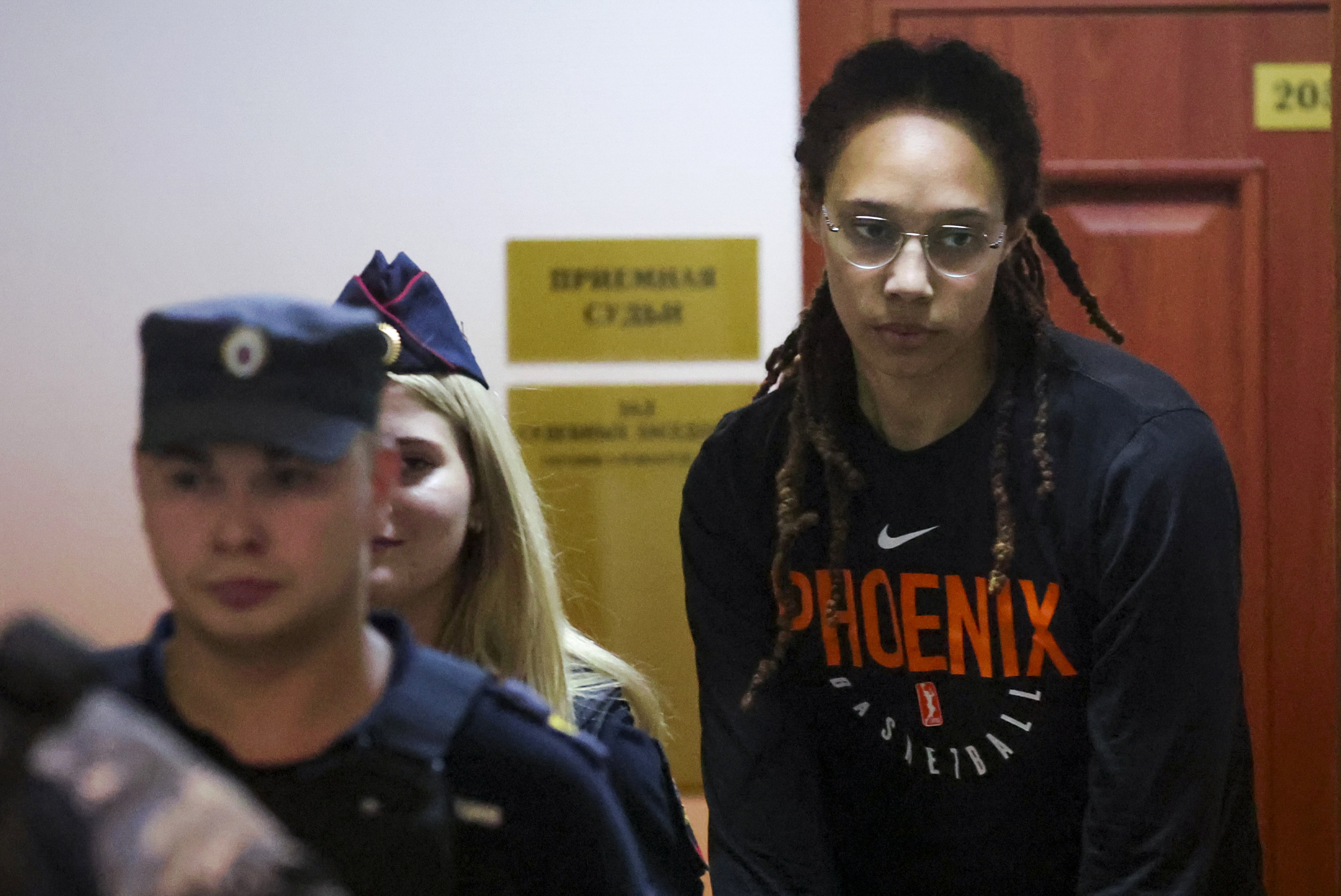 WNBA star and two-time Olympic gold medalist Brittney Griner is escorted to a courtroom for a hearing, in Khimki just outside Moscow, Russia, Wednesday, July 27, 2022. American basketball star Brittney Griner returned Wednesday to a Russian courtroom for her drawn-out trial on drug charges that could bring her 10 years in prison of convicted. 