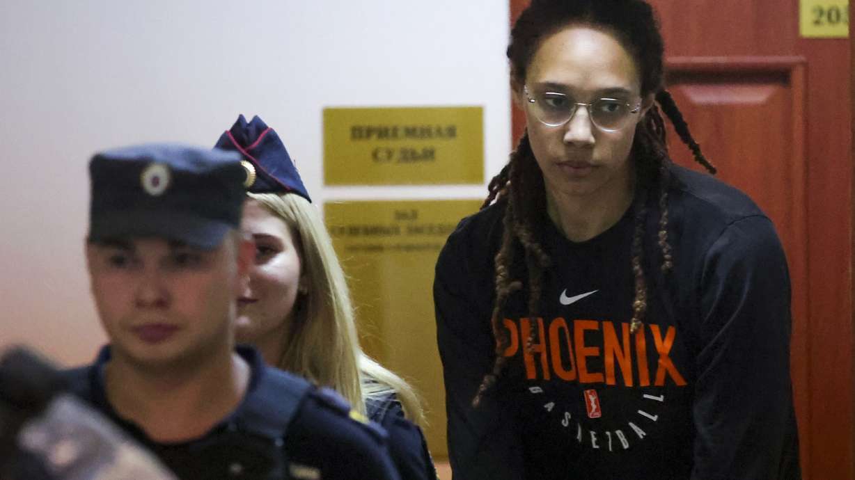 WNBA star and two-time Olympic gold medalist Brittney Griner is escorted to a courtroom for a hearing, in Khimki just outside Moscow, Russia, Wednesday, July 27, 2022. American basketball star Brittney Griner returned Wednesday to a Russian courtroom for her drawn-out trial on drug charges that could bring her 10 years in prison of convicted.