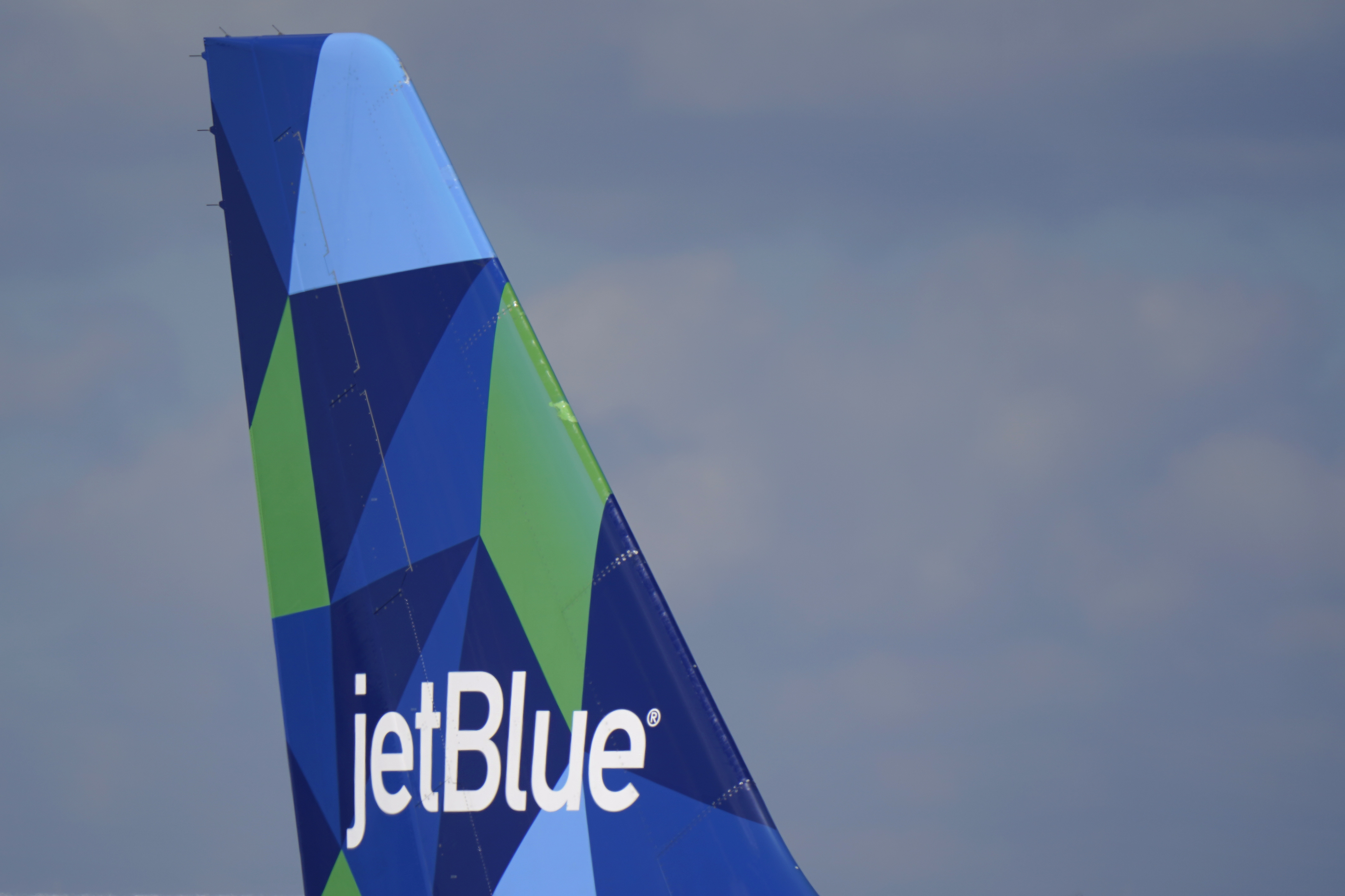 The tail of a JetBlue Airways Airbus A321 is shown Jan. 19, 2021, in Fort Lauderdale, Fla. JetBlue is buying Spirit Airlines Thursday in a $3.8 billion deal.