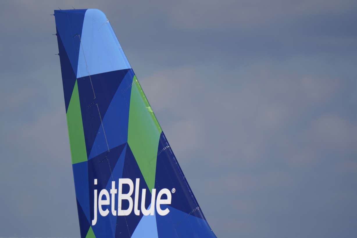 The tail of a JetBlue Airways Airbus A321 is shown Jan. 19, 2021, in Fort Lauderdale, Fla. JetBlue is buying Spirit Airlines Thursday in a $3.8 billion deal.
