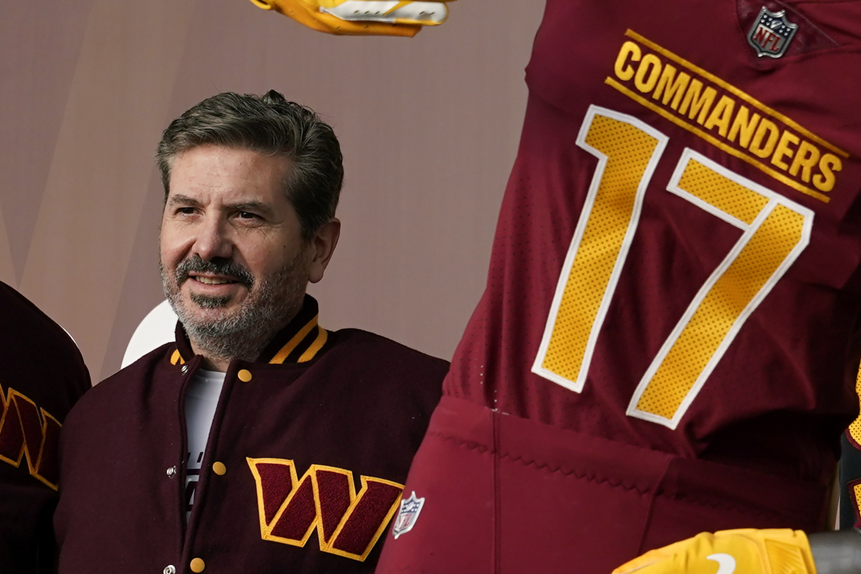 FILE - Washington Commanders' Dan Snyder poses for photos during an event to unveil the NFL football team's new identity, Wednesday, Feb. 2, 2022, in Landover, Md. Snyder is set to testify later Thursday morning, July 28, before a congressional committee that is investigating the NFL team’s history of workplace misconduct. 