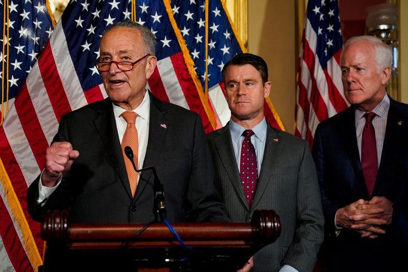 U.S. Senate Majority Leader Chuck Schumer, D-N.Y., speaks as U.S. Senators Todd Young, R-Indiana, and John Cornyn, R-Texas, listen during a news conference after the U.S. Senate passed legislation to subsidize the domestic semiconductor industry, at the U.S. Capitol in Washington, Wednesday.