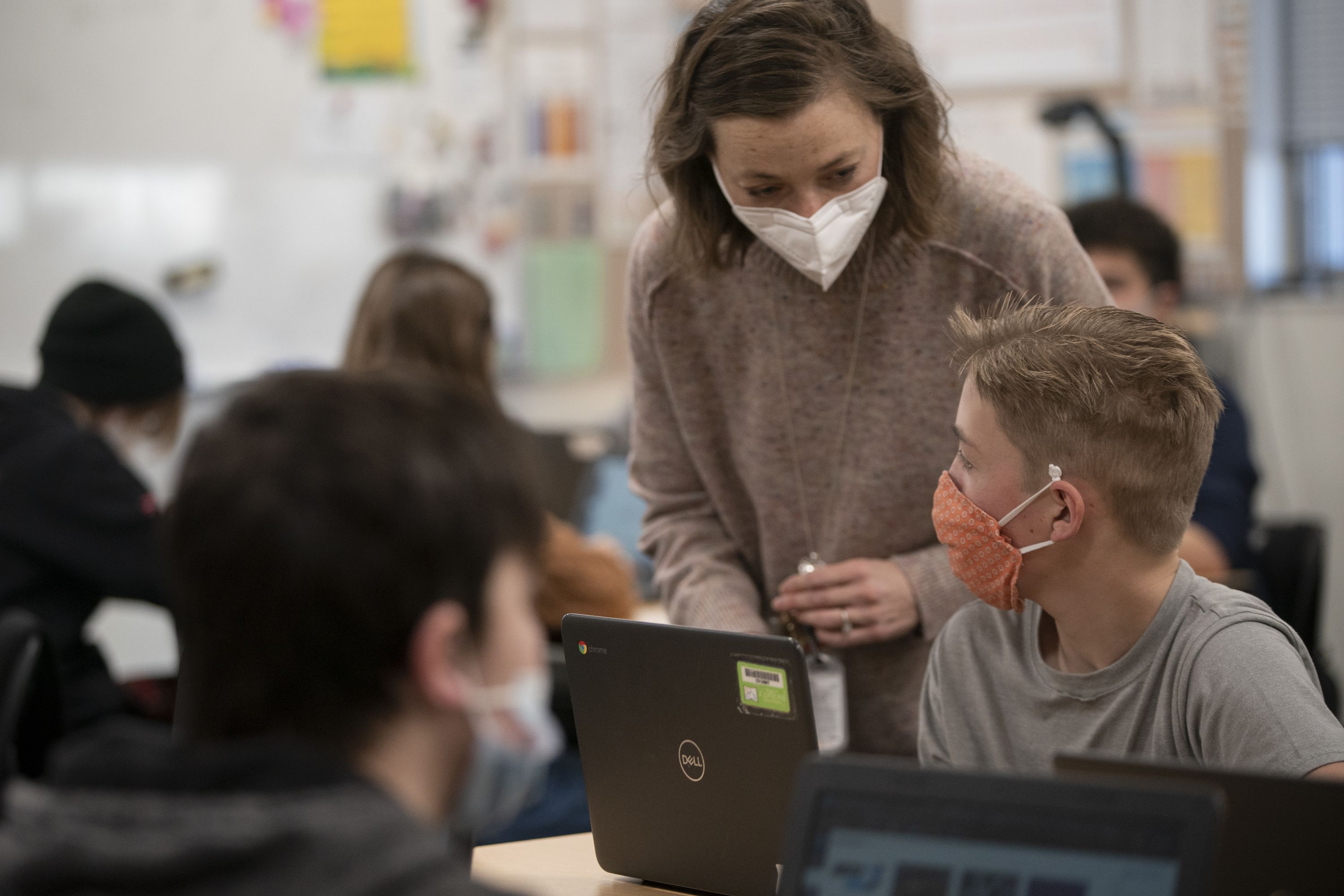 Eighth grade students and their teacher wear masks during their dual language class at Mount Jordan Middle School in Sandy on Jan. 10. Some schools in the nation are requiring masks again as COVID-19 case counts rise.