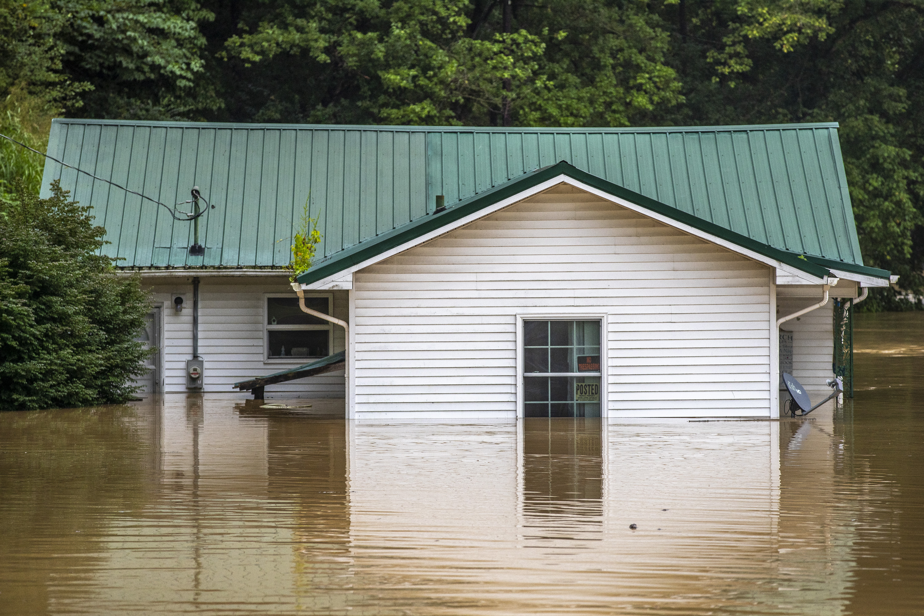 Homes are flooded by Lost Creek, Ky., on Thursday. Heavy rains have caused flash flooding and mudslides as storms pound parts of central Appalachia. Kentucky Gov. Andy Beshear says it's some of the worst flooding in state history.