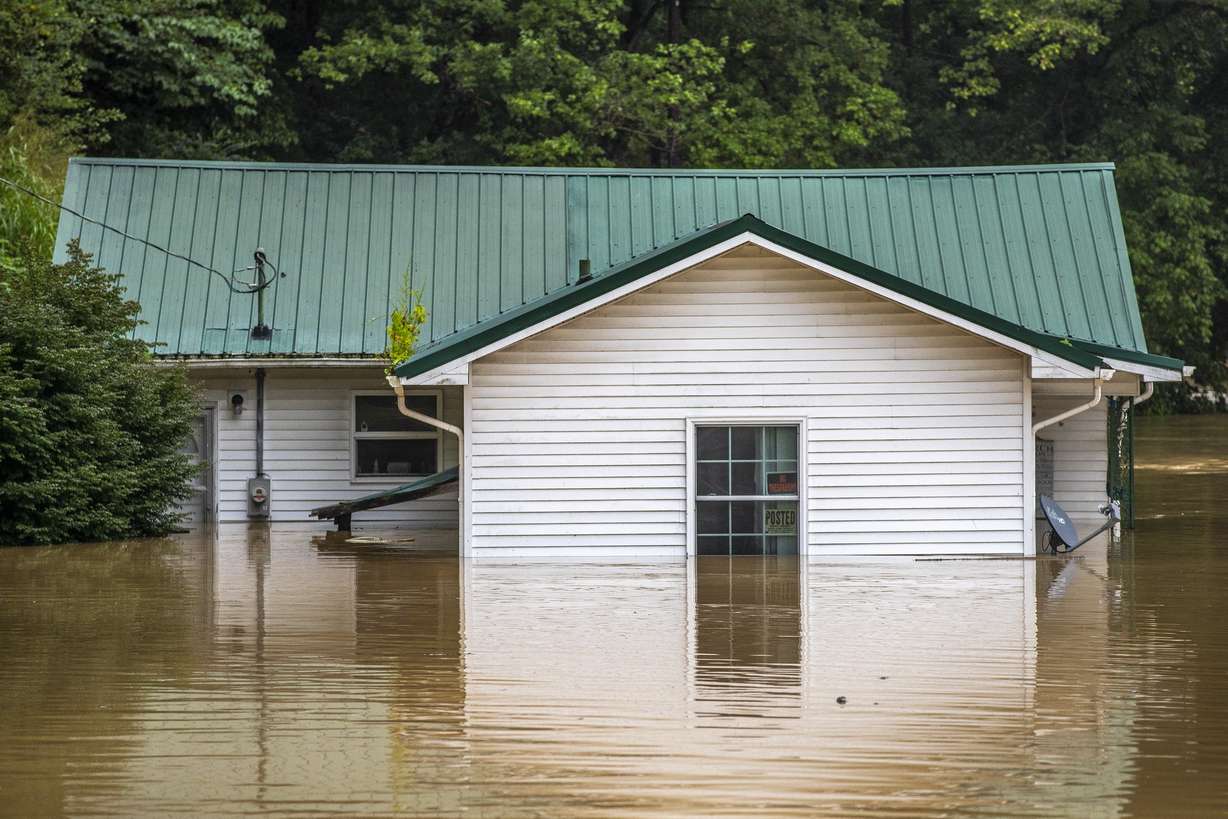 Homes are flooded by Lost Creek, Ky., on Thursday. Heavy rains have caused flash flooding and mudslides as storms pound parts of central Appalachia. Kentucky Gov. Andy Beshear says it's some of the worst flooding in state history.