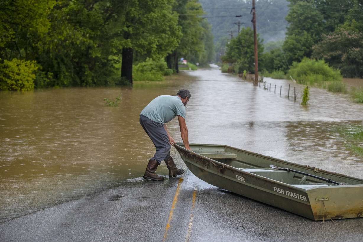 A man prepares to launch a boat near flooded Wolverine Road in Breathitt County, Ky., on Thursday.