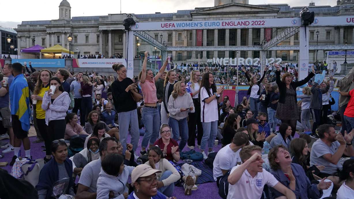FILE - England supporters celebrate after Beth Mead scored the opening goal as they watch a live screening of the Women's Euro 2022 semifinal soccer match between England and Sweden at the fan area in Trafalgar Square in London, England, Tuesday, July 26, 2022. The march to Sunday's final against Germany has energized people throughout England, with the team's pinpoint passing and flashy goals attracting record crowds, burgeoning TV ratings and adoring coverage. The Lionesses, as the team is known, have been a welcome distraction from the political turmoil and cost-of-living crisis that dominate the headlines.