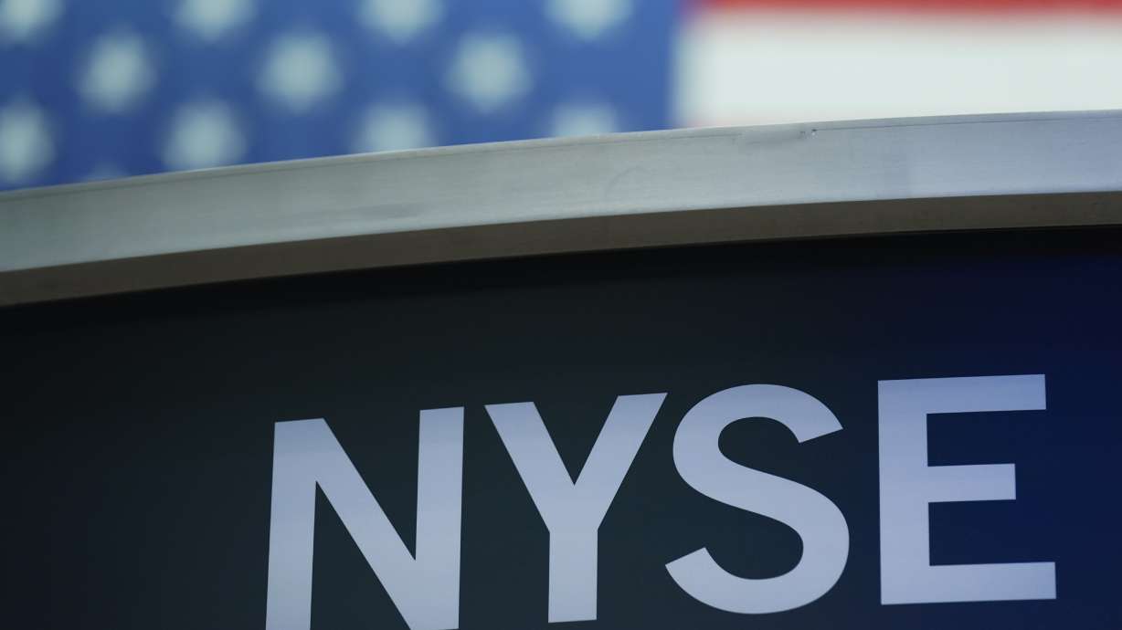 A sign for New York Stock Exchange is displayed on the floor at the NYSE in New York, Wednesday, July 27. Stocks were modestly higher early Friday, on Wall Street, despite news that closely watched inflation data jumped by the most in four decades last month.