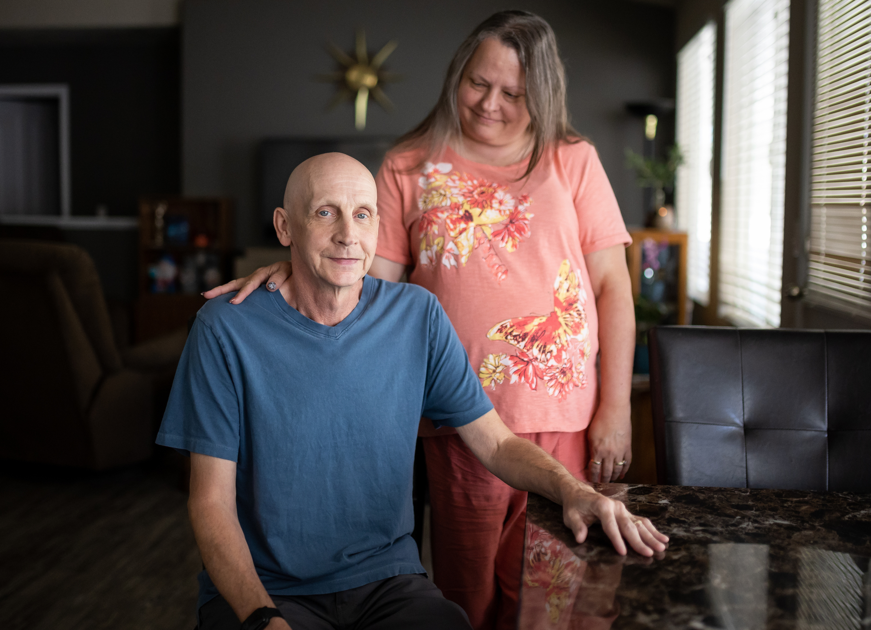Shawn Moriarty and his wife, Kelly, pose for a photo at their home in Magna on Tuesday. Shawn Moriarty was seriously injured in May after his car was struck head-on by one of two vehicles that were chasing each other during an altercation between their drivers, police say.