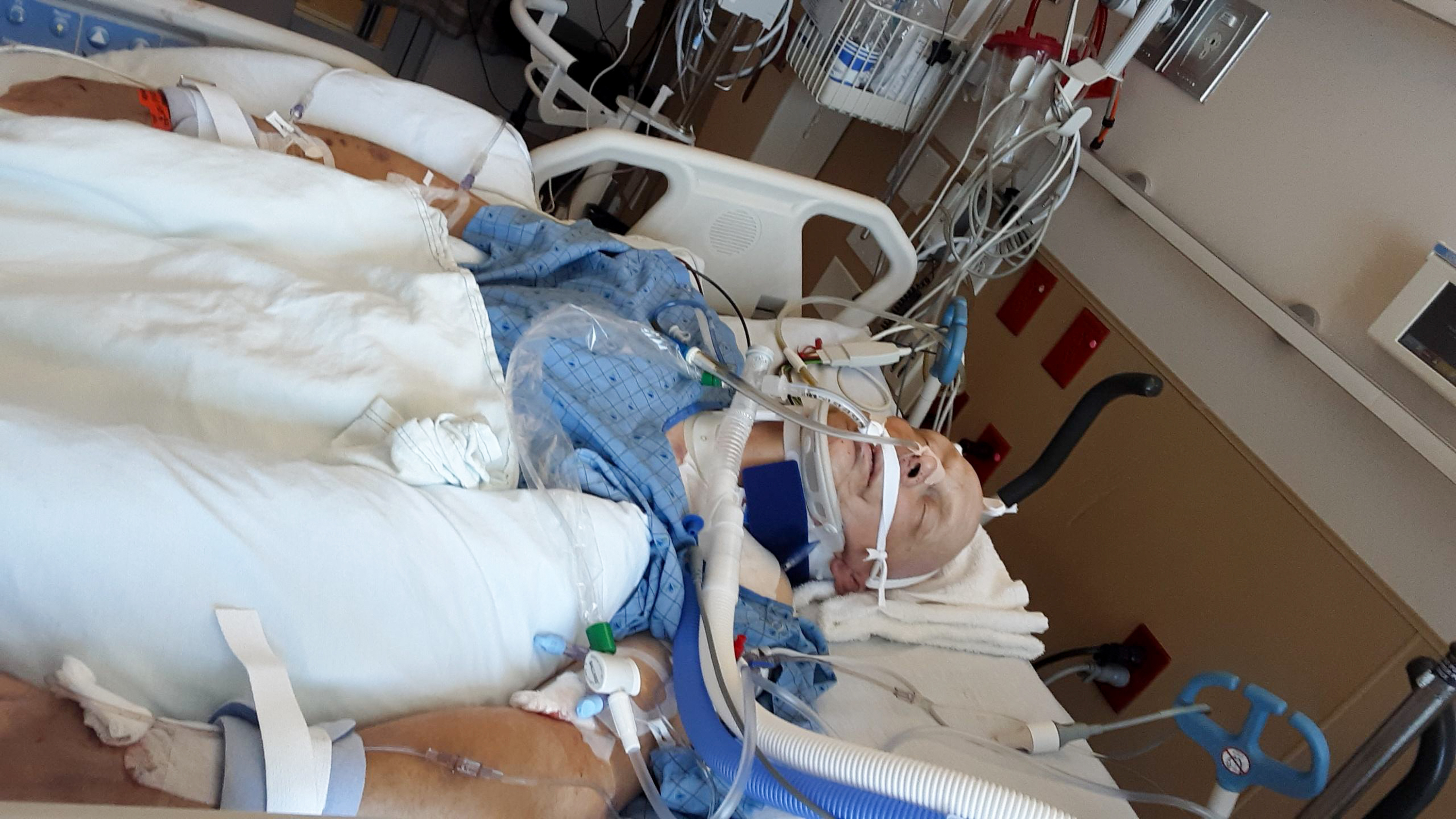 Shawn Moriarty is pictured in his hospital bed after emergency surgery on May 24 after being seriously injured when his car was struck by one of two men involved in a car chase in Salt Lake City, police say.