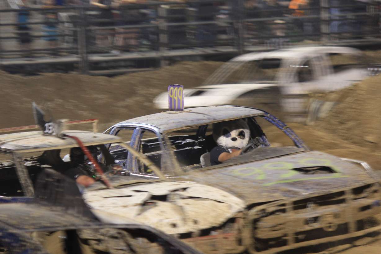 Tomas Colqui wears a panda head over his racing helmet, even though he says the nose makes it harder to see the track at Trash Car Racing in Logan on July 16.