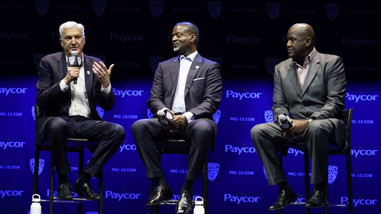 George Kliavkoff, Commissioner of the Pac-12 Conference, left, with Senior Associate Commissioner Merton Hanks, center, and Stanford Athletic Director Bernard Muir take questions from the media during opening of the Pac-12 NCAA college football media day Friday, July 29, 2022, in Los Angeles.