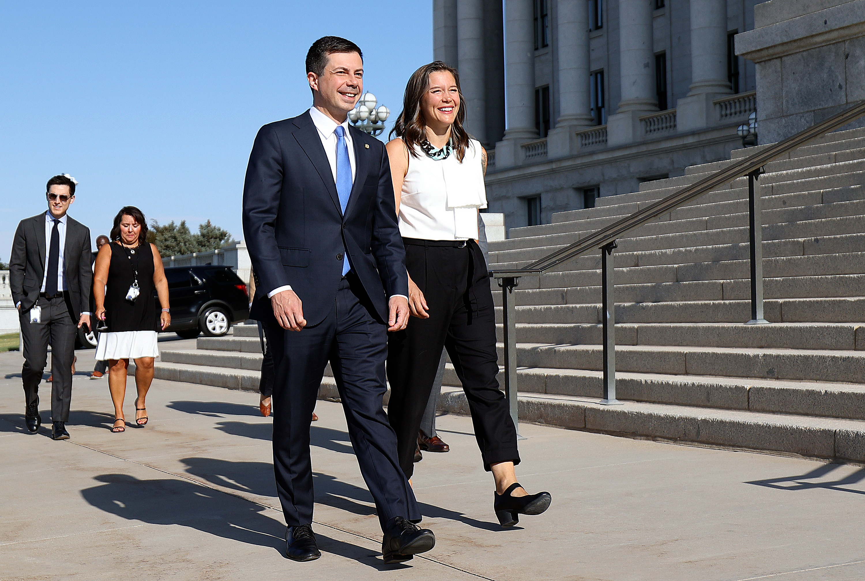 U.S. Secretary of Transportation Pete Buttigieg and Salt Lake City Mayor Erin Mendenhall walk outside of the Capitol in Salt Lake City before a press conference about new infrastructure projects on Friday.