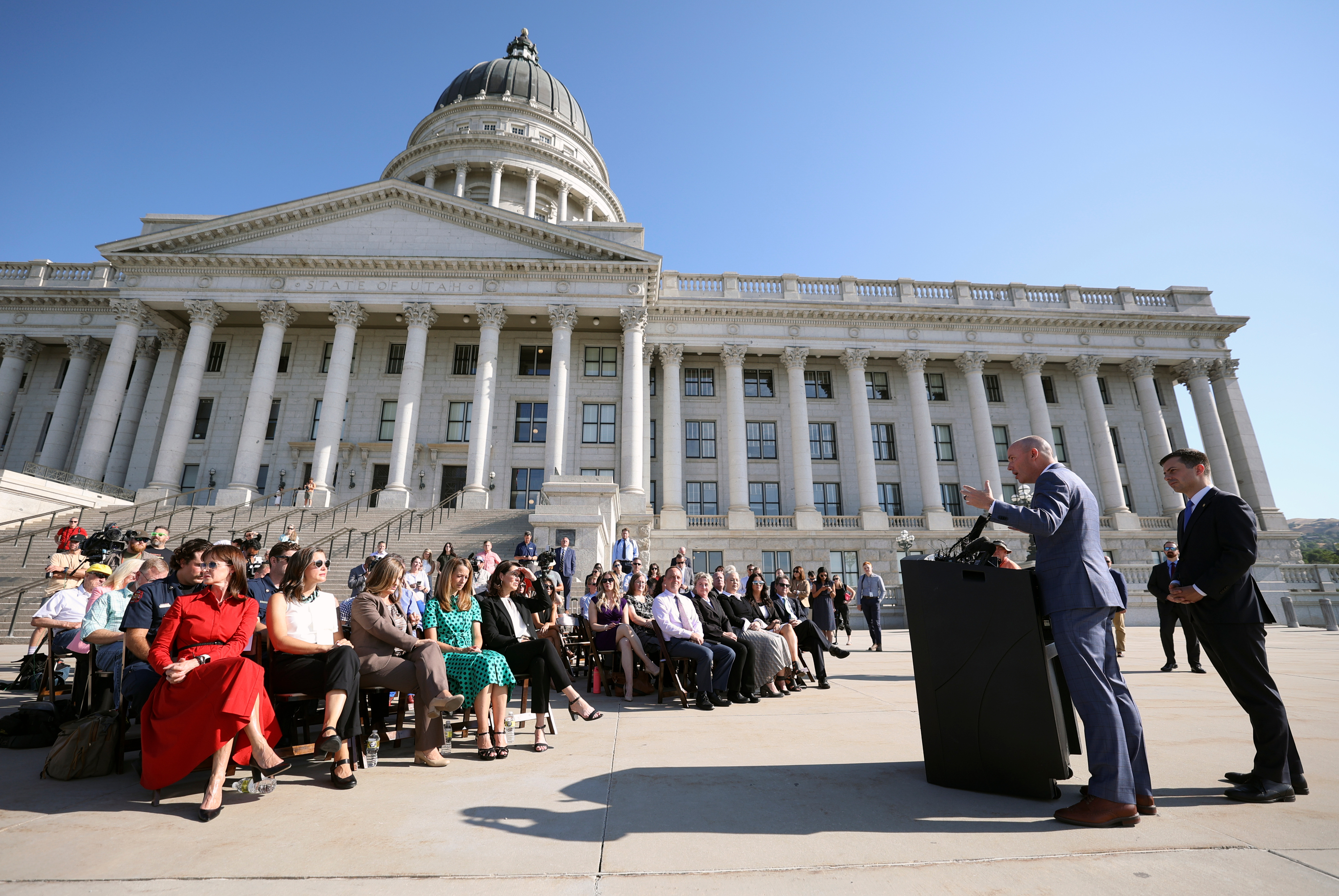 Gov. Spencer Cox speaks outside of the Capitol in Salt Lake City during a press conference with U.S. Secretary of Transportation Pete Buttigieg about new infrastructure projects to help build resilience to the impacts of extreme weather on Friday.