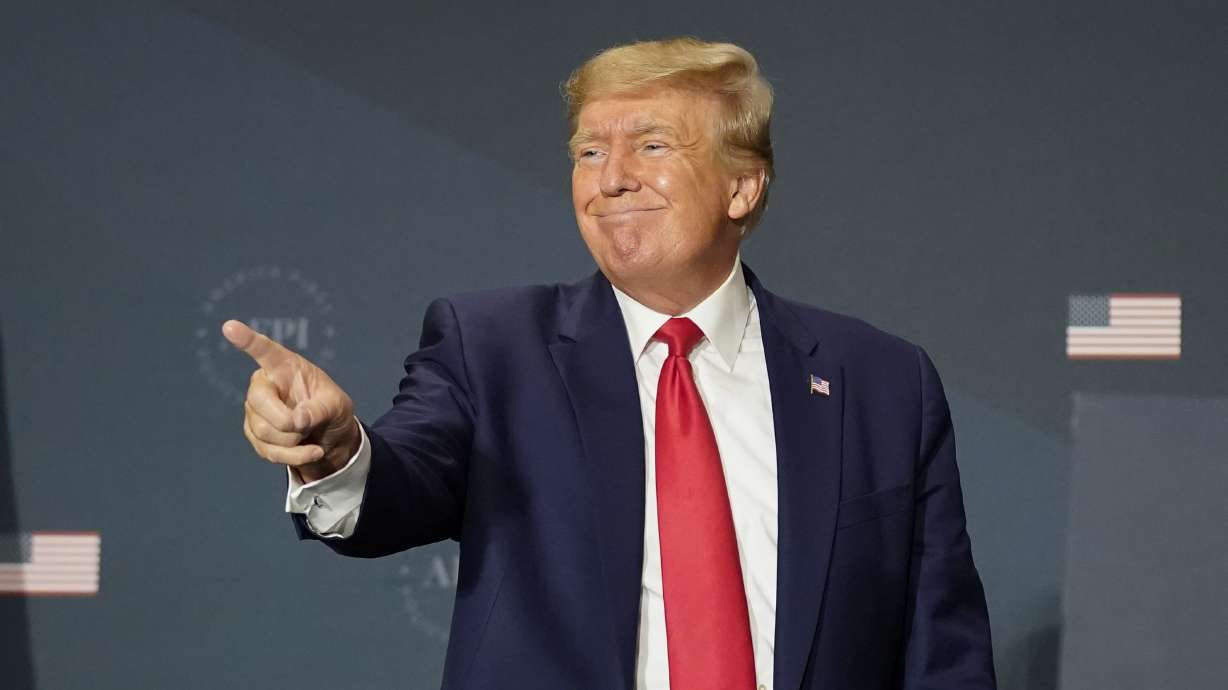 Former President Donald Trump gestures to the audience after speaking at an America First Policy Institute agenda summit at the Marriott Marquis in Washington on Tuesday.