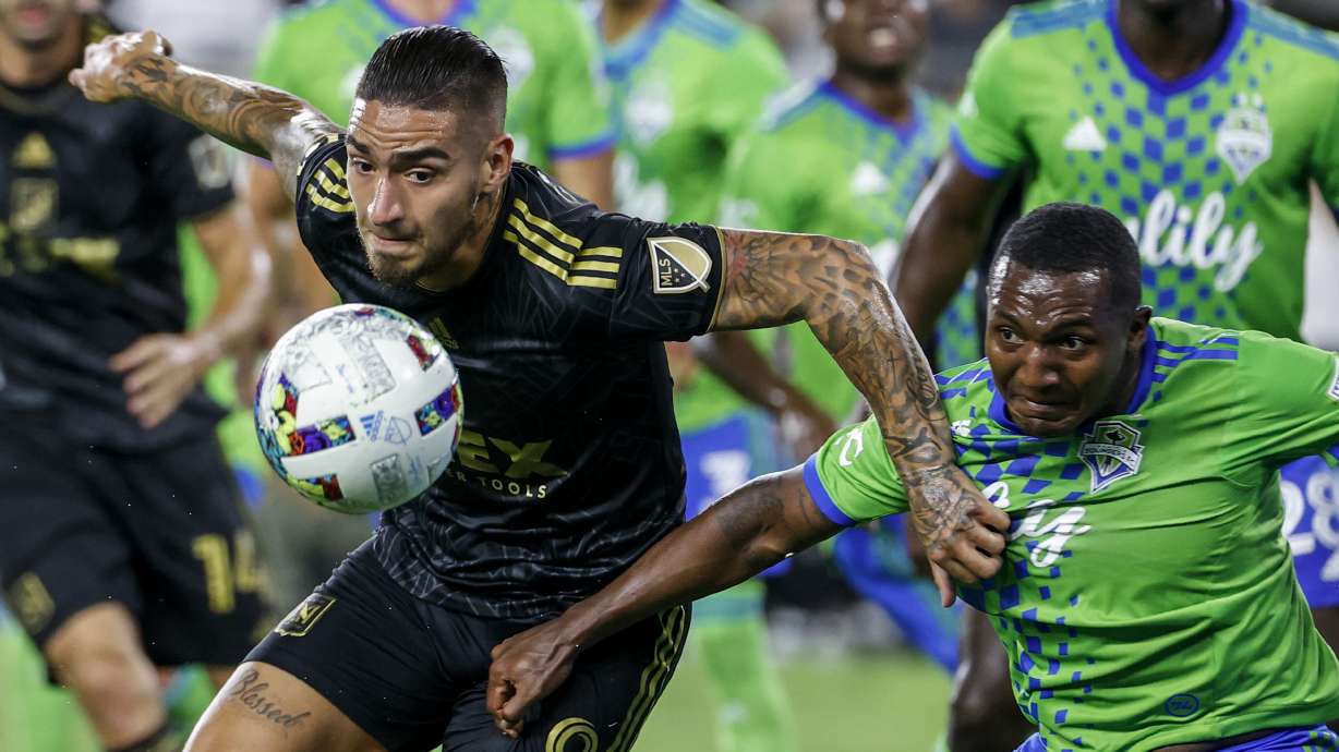 Los Angeles FC forward Cristian Arango, left, and Seattle Sounders defender Jimmy Medranda vie for the ball during the first half of an MLS soccer match Friday, July 29, 2022, in Los Angeles.