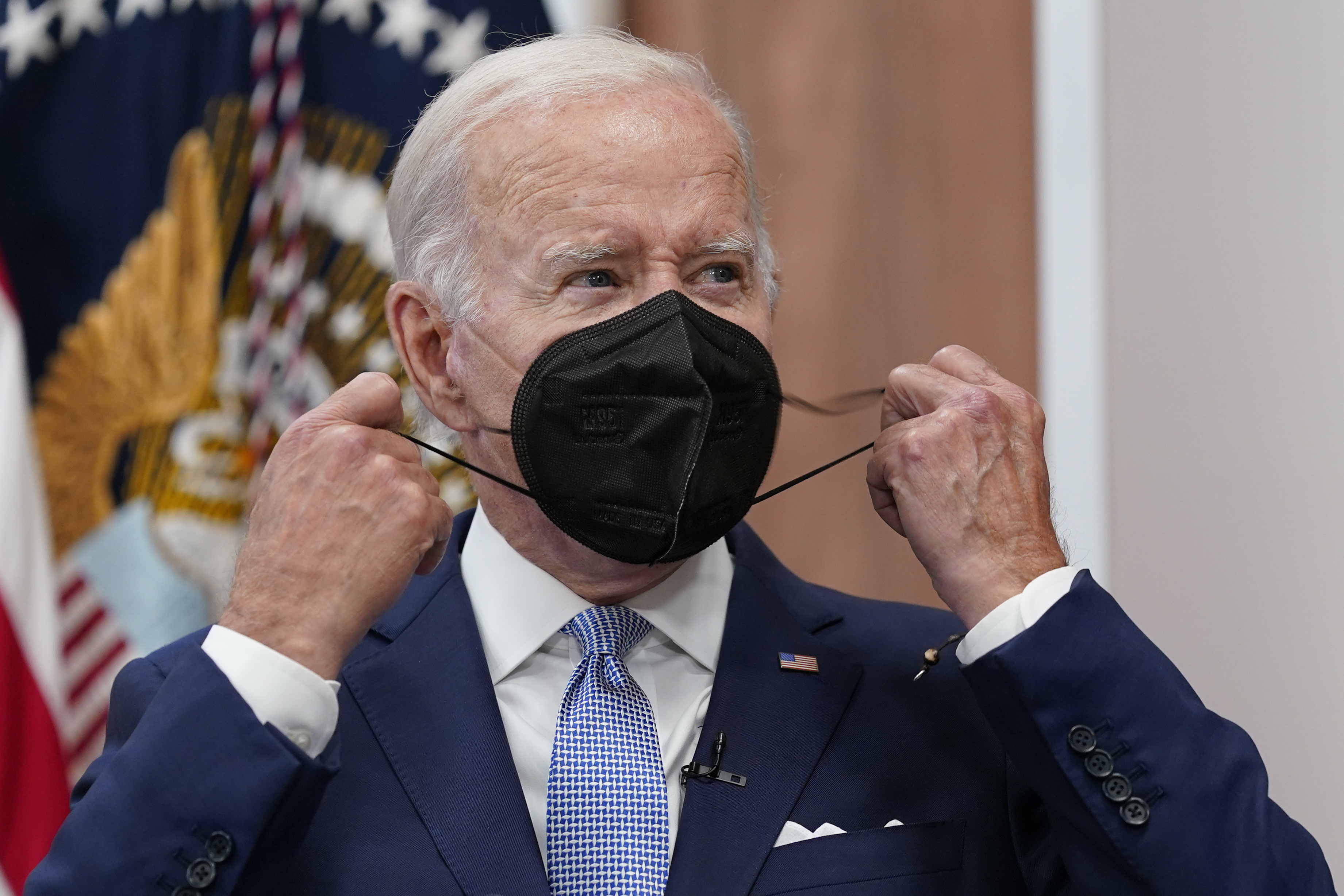 President Joe Biden removes his face mask as he arrives to speak about the economy during a meeting with CEOs in the South Court Auditorium on the White House complex in Washington, Thursday. Biden tested positive for COVID-19 again Saturday, July 30, slightly more than three days after he was cleared to exit coronavirus isolation, the White House said, in a rare case of “rebound” following treatment with an anti-viral drug. 