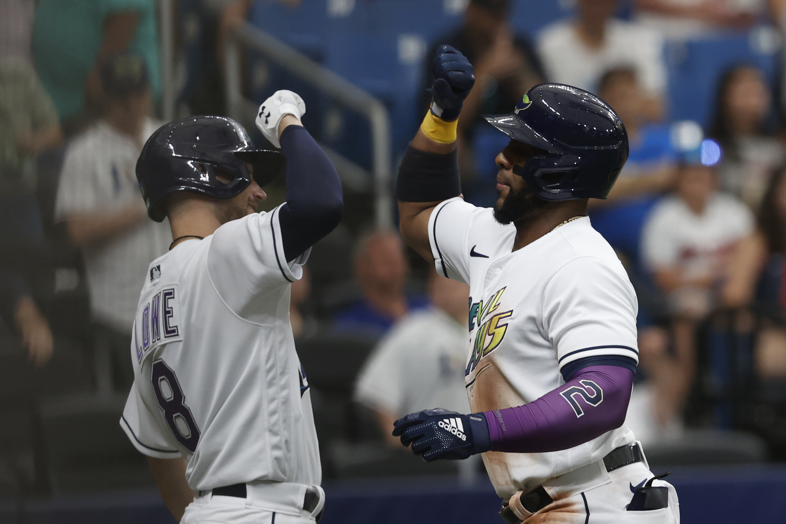 Tampa Bay Rays' Yandy Diaz, right, celebrates with teammate Brandon Lowe after hitting a home run against the Cleveland Guardians during the fifth inning of a baseball game Saturday, July 30, 2022, in St. Petersburg, Fla.