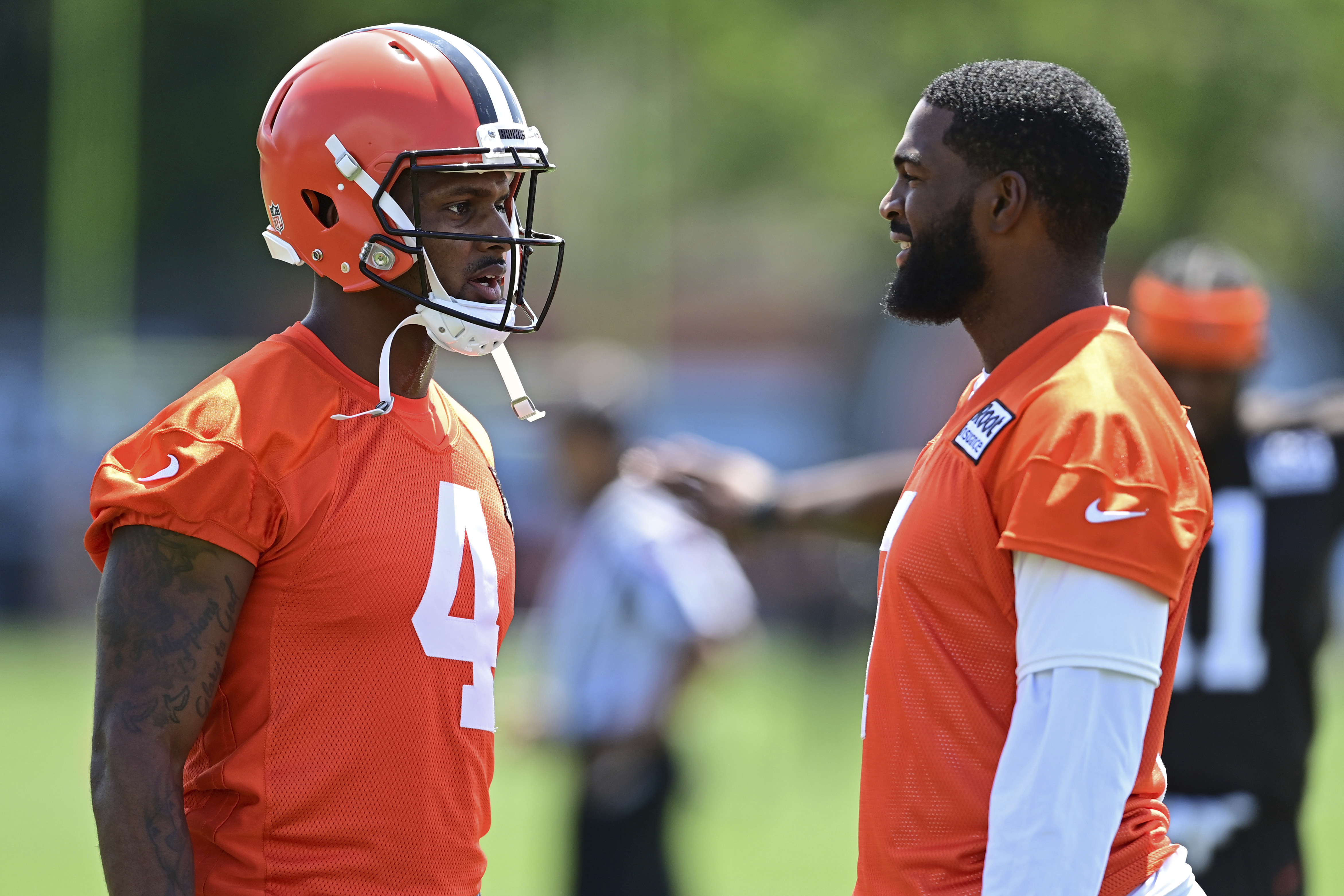 Cleveland Browns quarterbacks Deshaun Watson, left, and Jacoby Brissett talk before an NFL football practice in Berea, Ohio, Saturday, July 30, 2022. 