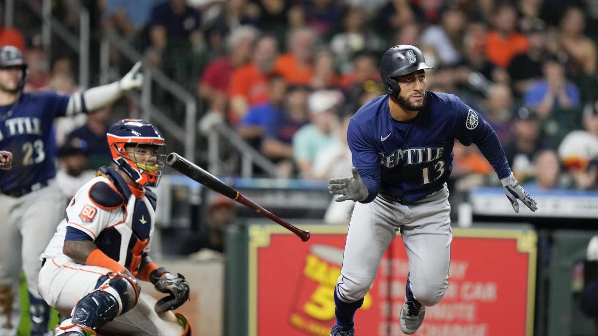 Seattle Mariners' Abraham Toro (13) watches his two-run single during the ninth inning of the team's baseball game against the Houston Astros, Saturday, July 30, 2022, in Houston.