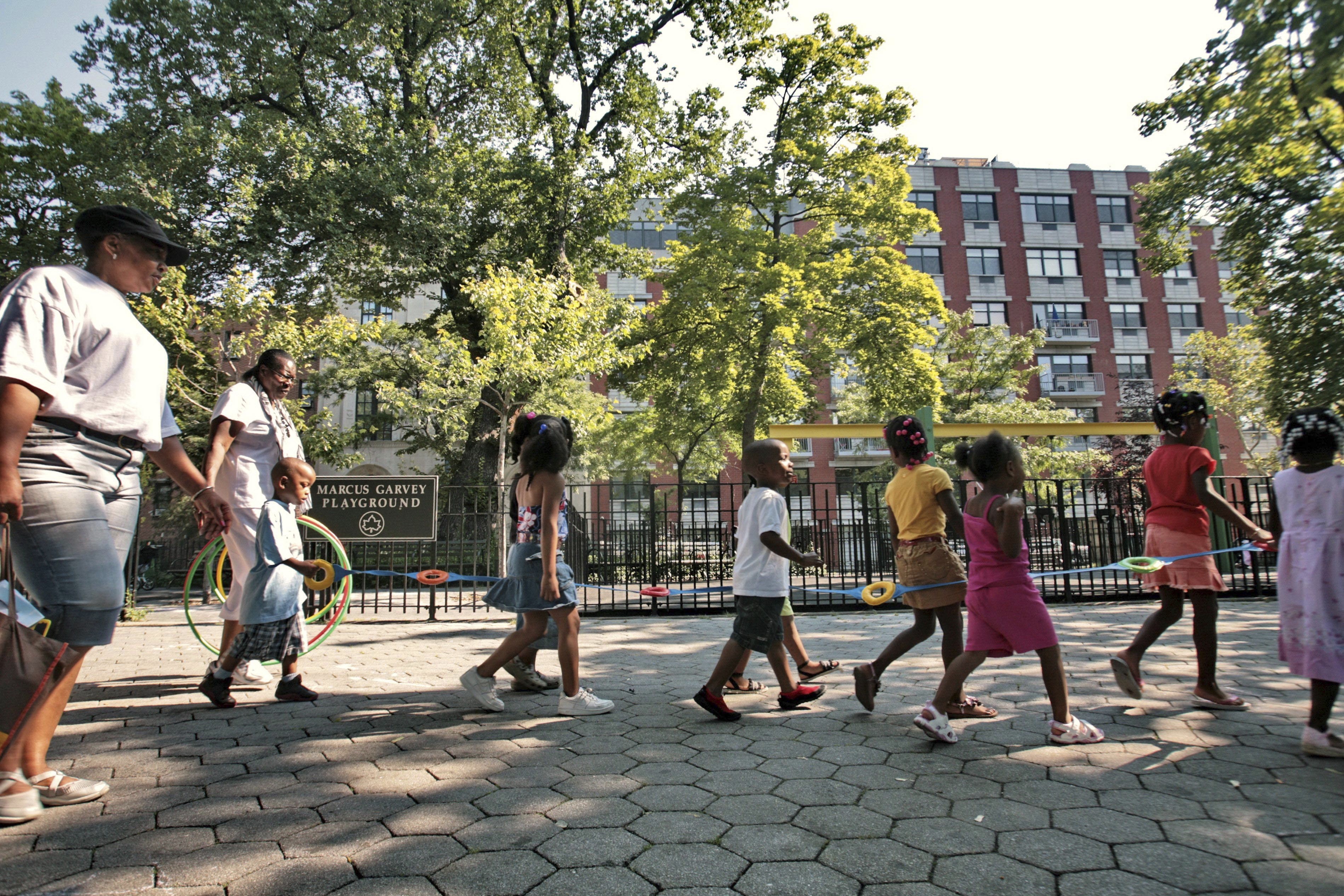 Children from a nearby daycare are escorted in Marcus Garvey Park in the Harlem neighborhood of New York Wednesday, Aug. 1, 2007. Some states have moved ahead with plans of their own to boost child care subsidies after a national effort by Democrats in Washington stalled. New York lawmakers passed a state budget in the spring that calls for it to spend $7 billion making child care more affordable over the next four years. 