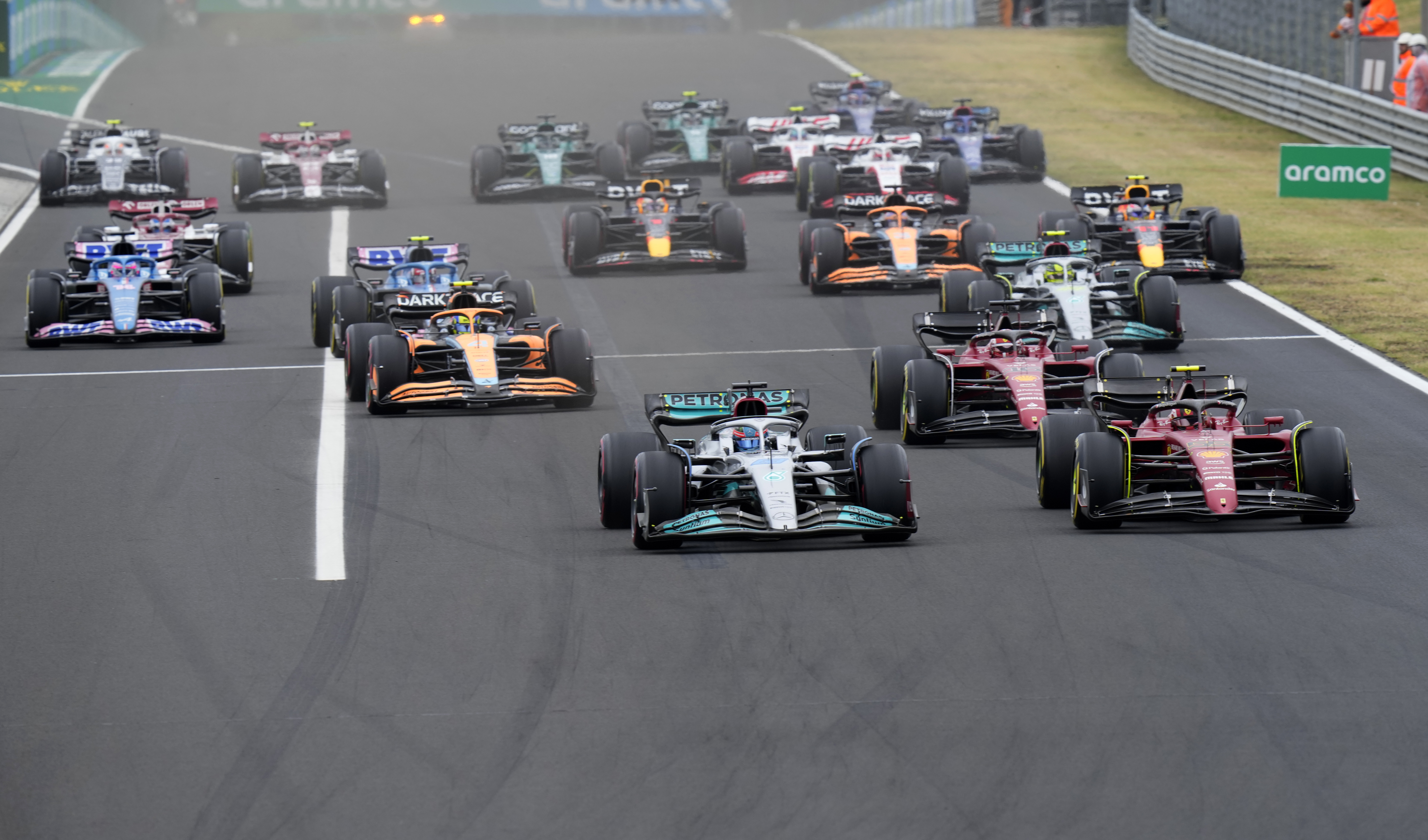 Mercedes driver George Russell of Britain, front left, leads at the start and followed by Ferrari driver Carlos Sainz of Spain during the Hungarian Formula One Grand Prix at the Hungaroring racetrack in Mogyorod, near Budapest, Hungary, Sunday, July 31, 2022.