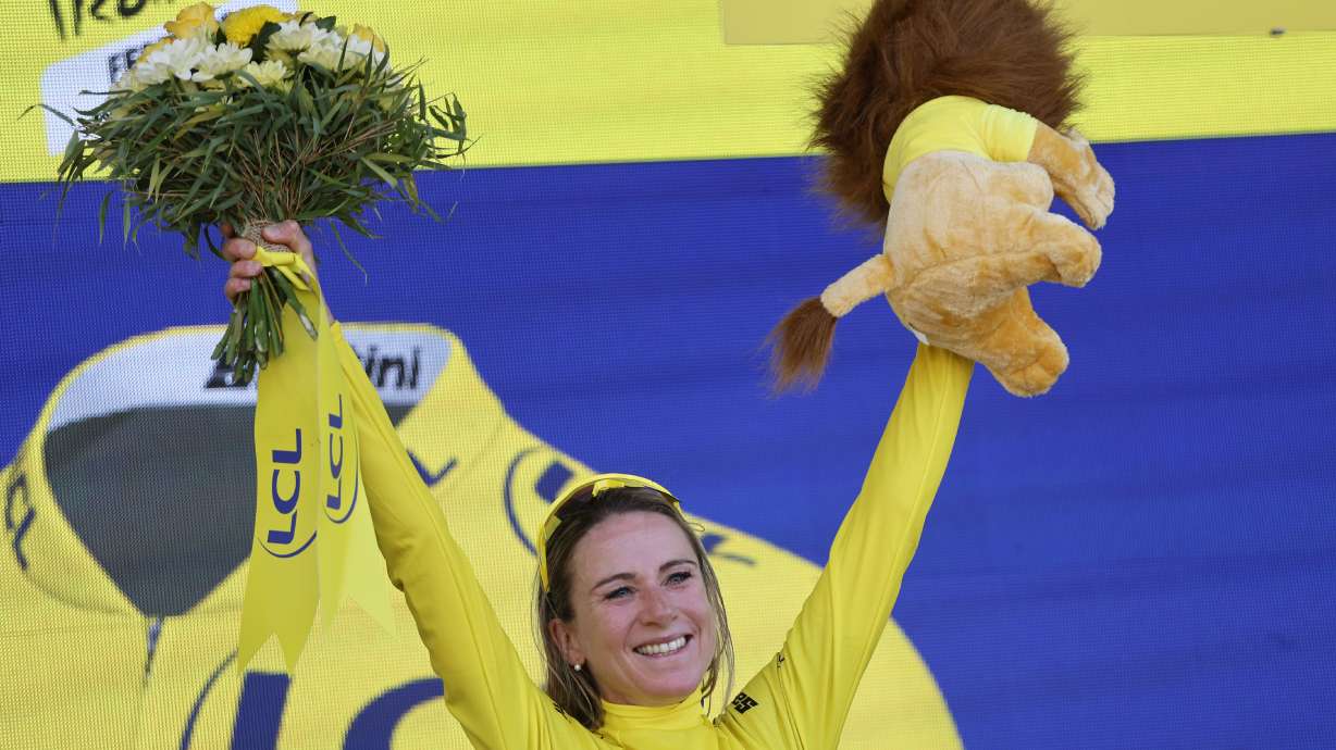 Netherland's Annemiek Van Vleuten, wearing the overall leader's yellow jersey, celebrates on the podium after winning the Tour de France women's cycling race, in La Super Planche des Belles Filles, eastern France, Sunday, July 31, 2022.