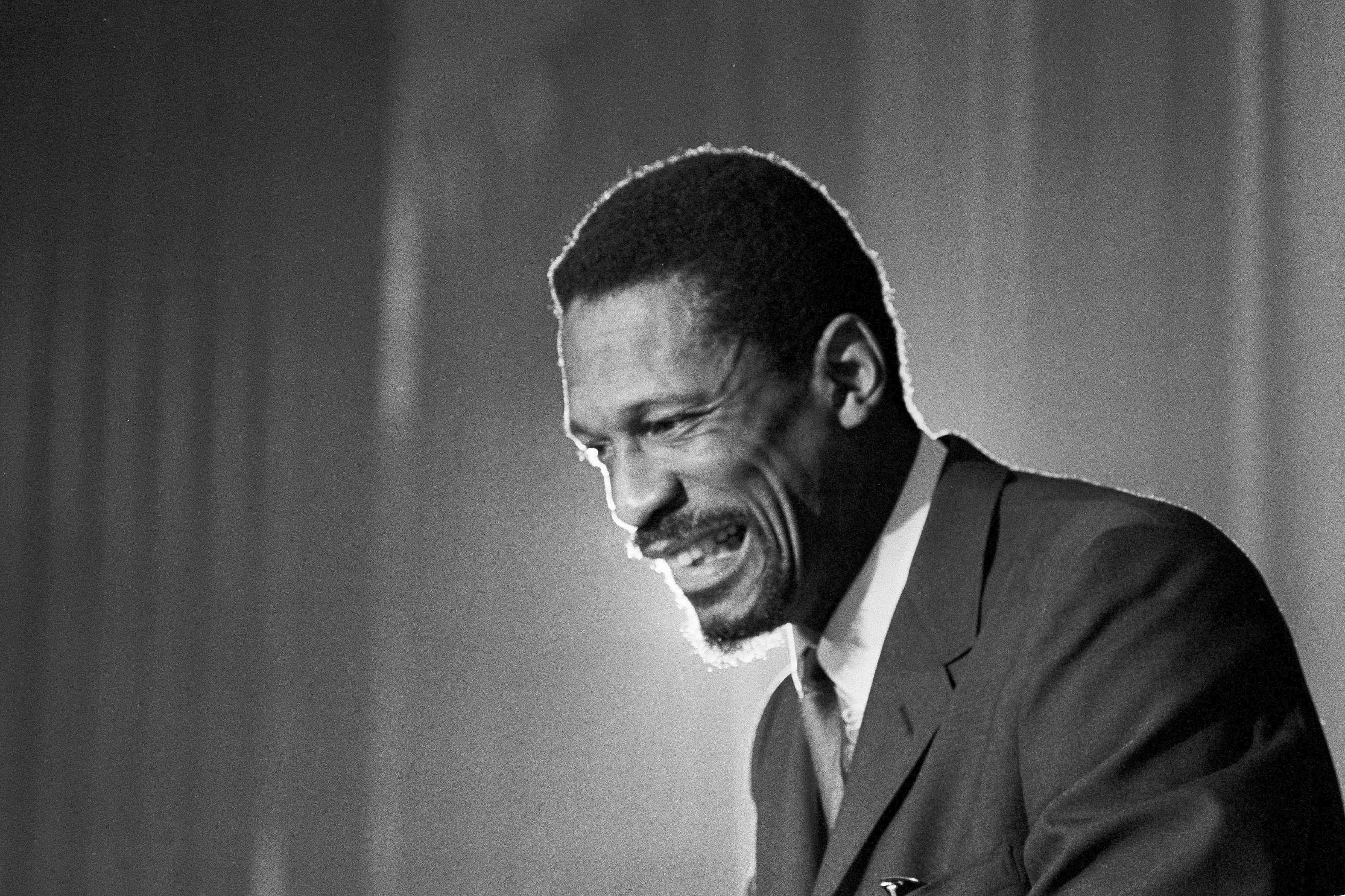 Bill Russell grins at announcement that he had been named coach of the Boston Celtics basketball team, April 18, 1966. 