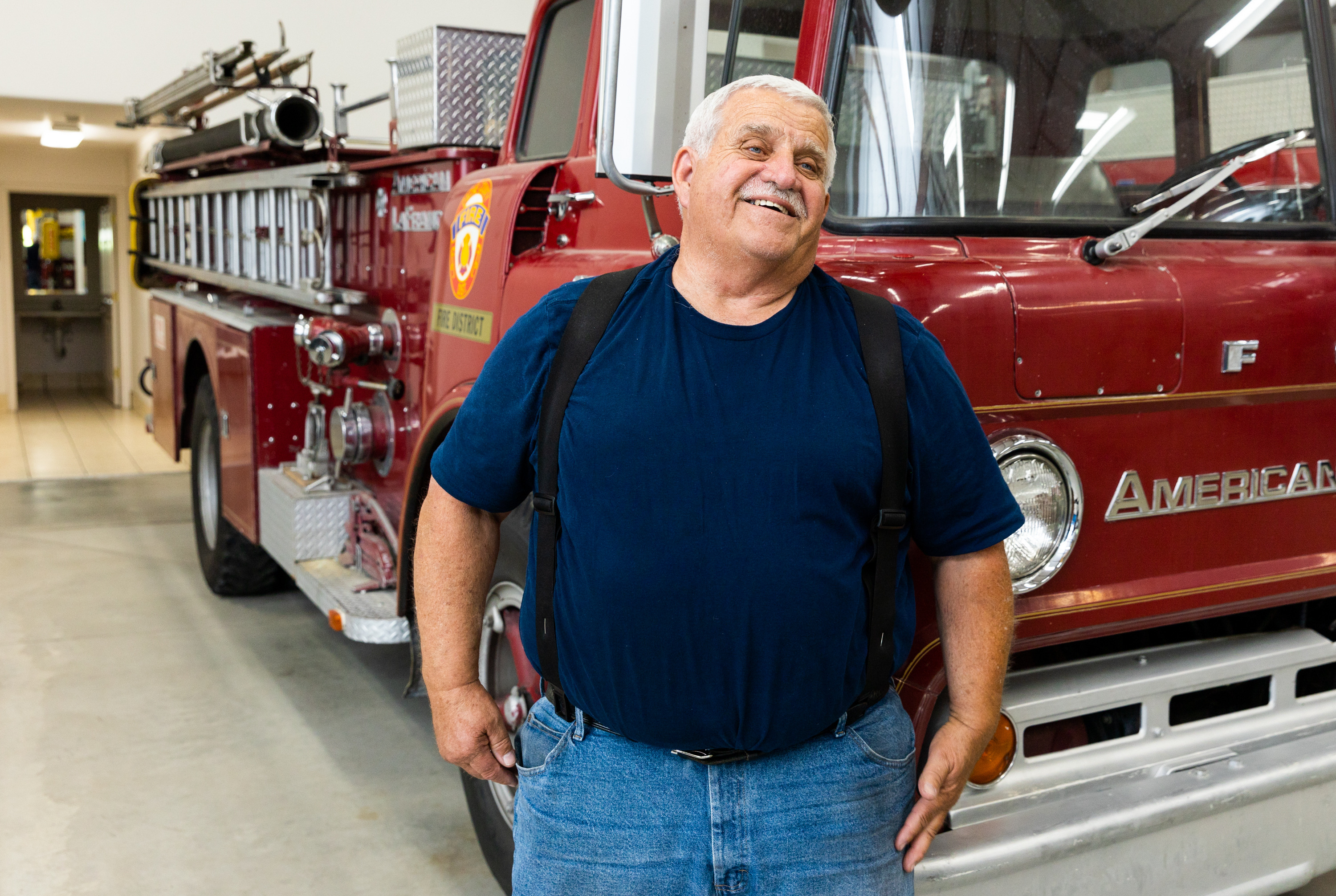 Ray Olsen, a volunteer fire chief, stands next to a vintage fire truck in Mendon, Cache County, on July 12. The truck is being auctioned off by the station in hopes to purchase new gear.