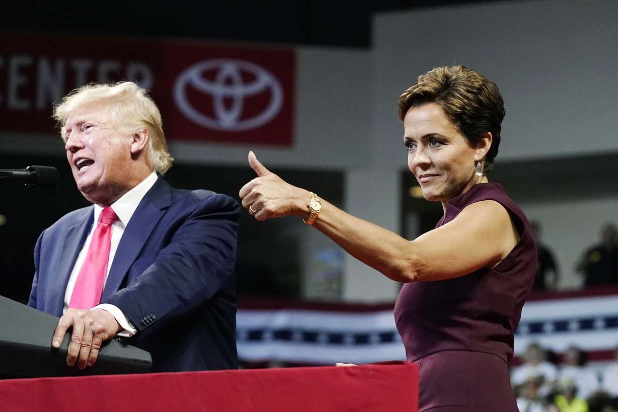 Arizona Republican candidate for governor, Kari Lake, gives a thumbs up to the crows as former President Donald Trump speaks at a Save America rally Friday, July 22, in Prescott, Ariz.