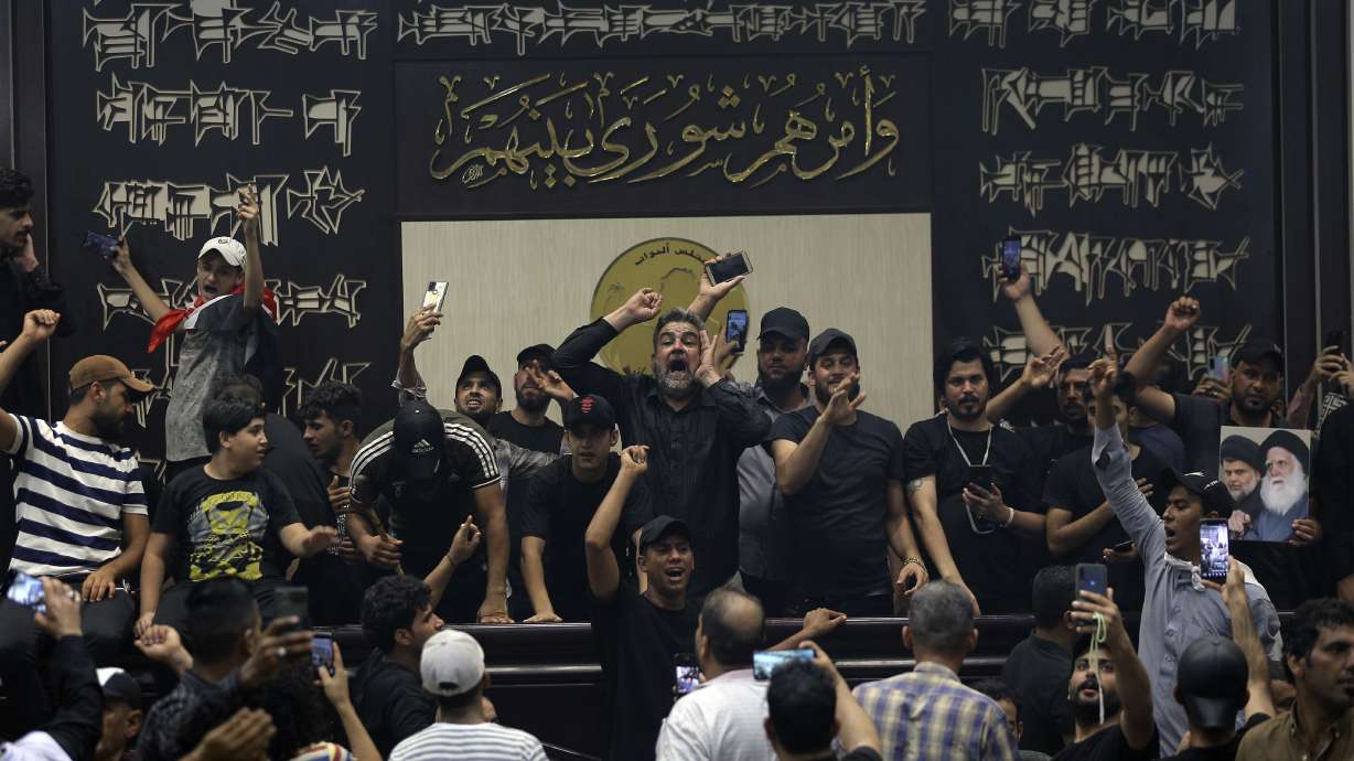 Iraqi protesters, mostly followers of Shiite cleric Muqtada al-Sadr, fill the parliament building in Baghdad, Iraq, Sunday.